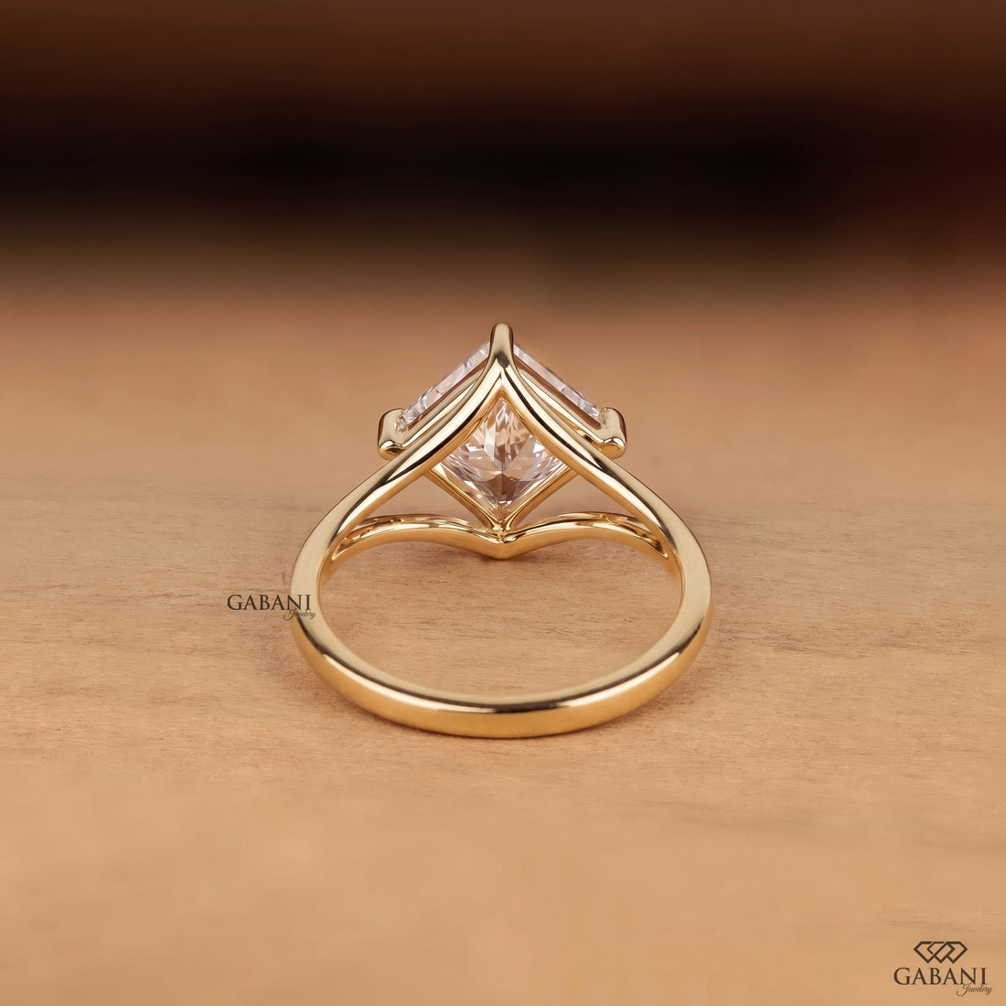 Princess cut lab grown diamond engagement ring in yellow gold featuring a kite set center stone, four prong setting, and modern open split shank design.