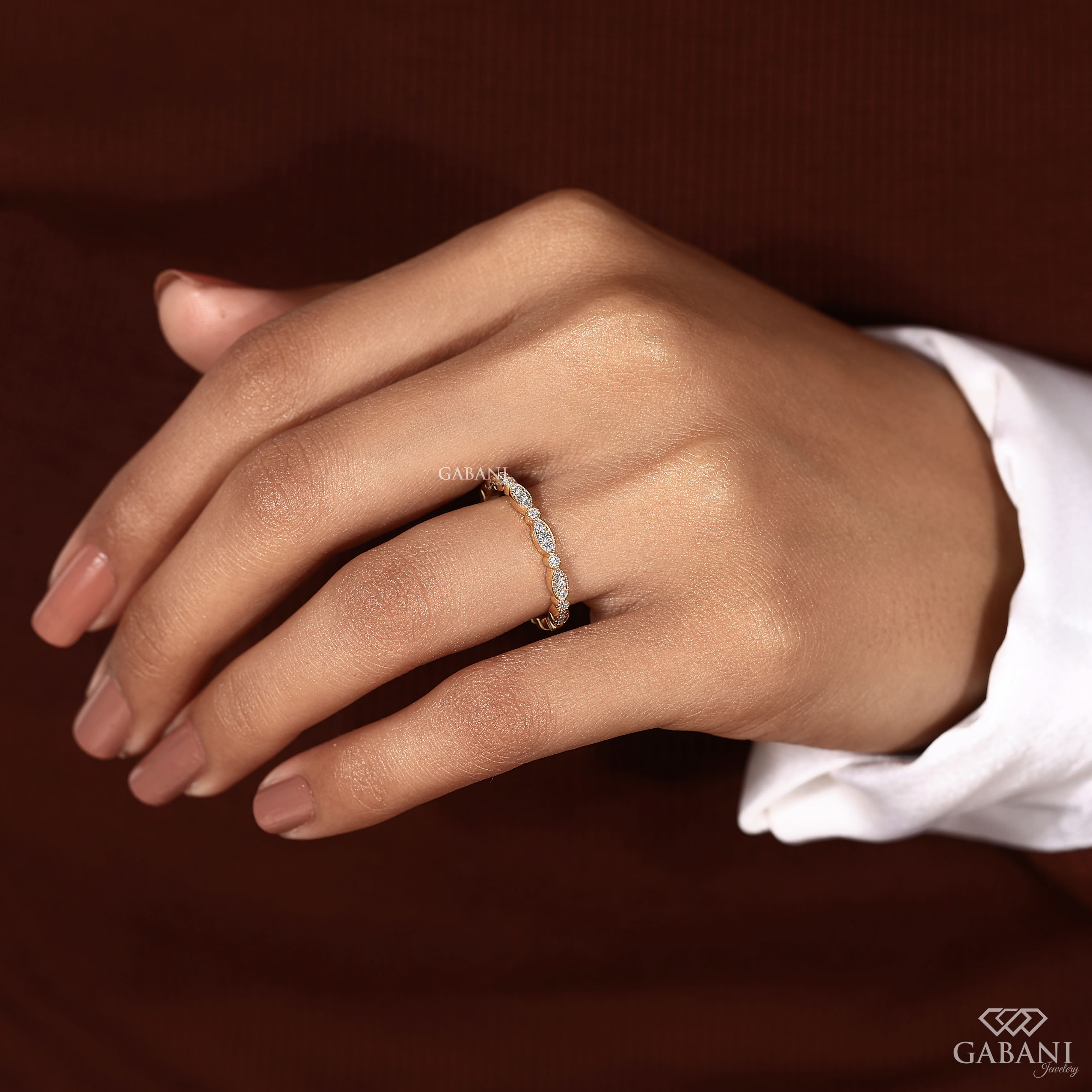 a round cut lab grown diamond wedding band in 14K yellow gold, featuring marquise-inspired diamond clusters, delicate milgrain detailing and a vintage design by Gabani Jewelry.