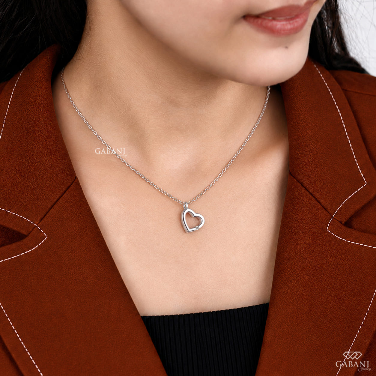 Open heart lab grown diamond pendant necklace in polished white gold featuring a single round cut diamond accent and delicate link chain.