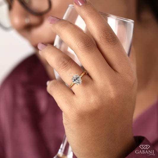 pear shaped lab grown diamond solitaire ring with minimal yellow gold band
