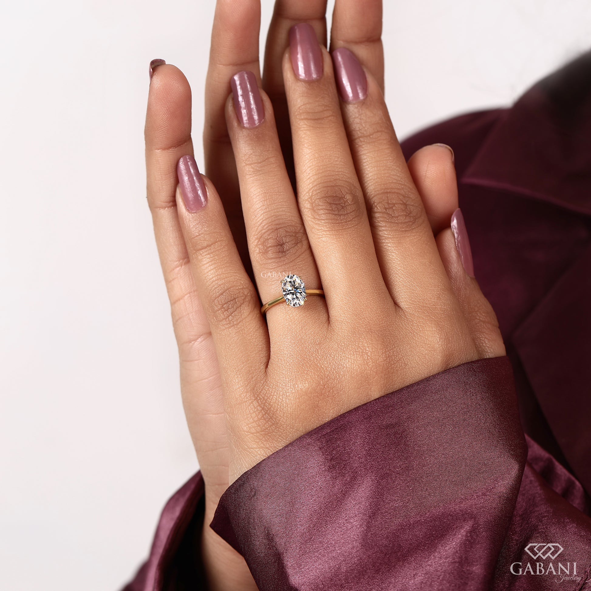 oval cut IGI certified lab grown diamond solitaire ring with open tulip basket setting and refined minimal look