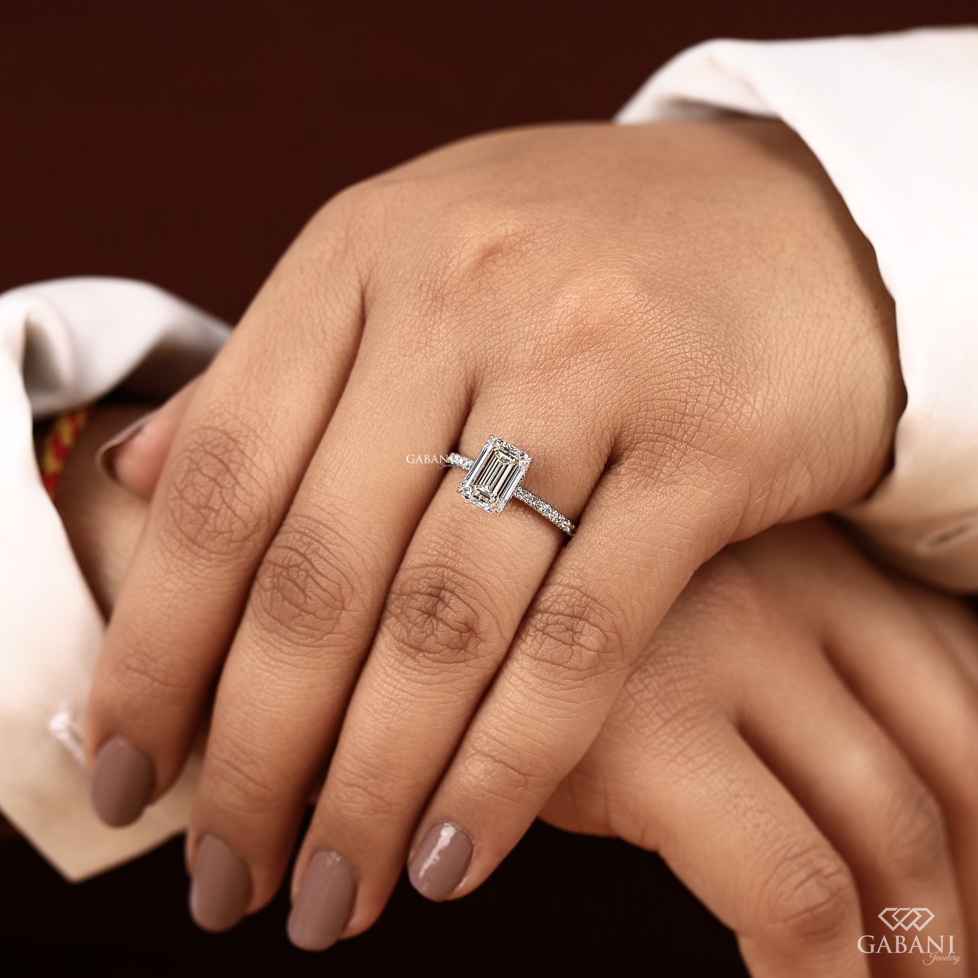 white gold engagement ring featuring emerald cut lab created diamond with prong setting and hidden halo