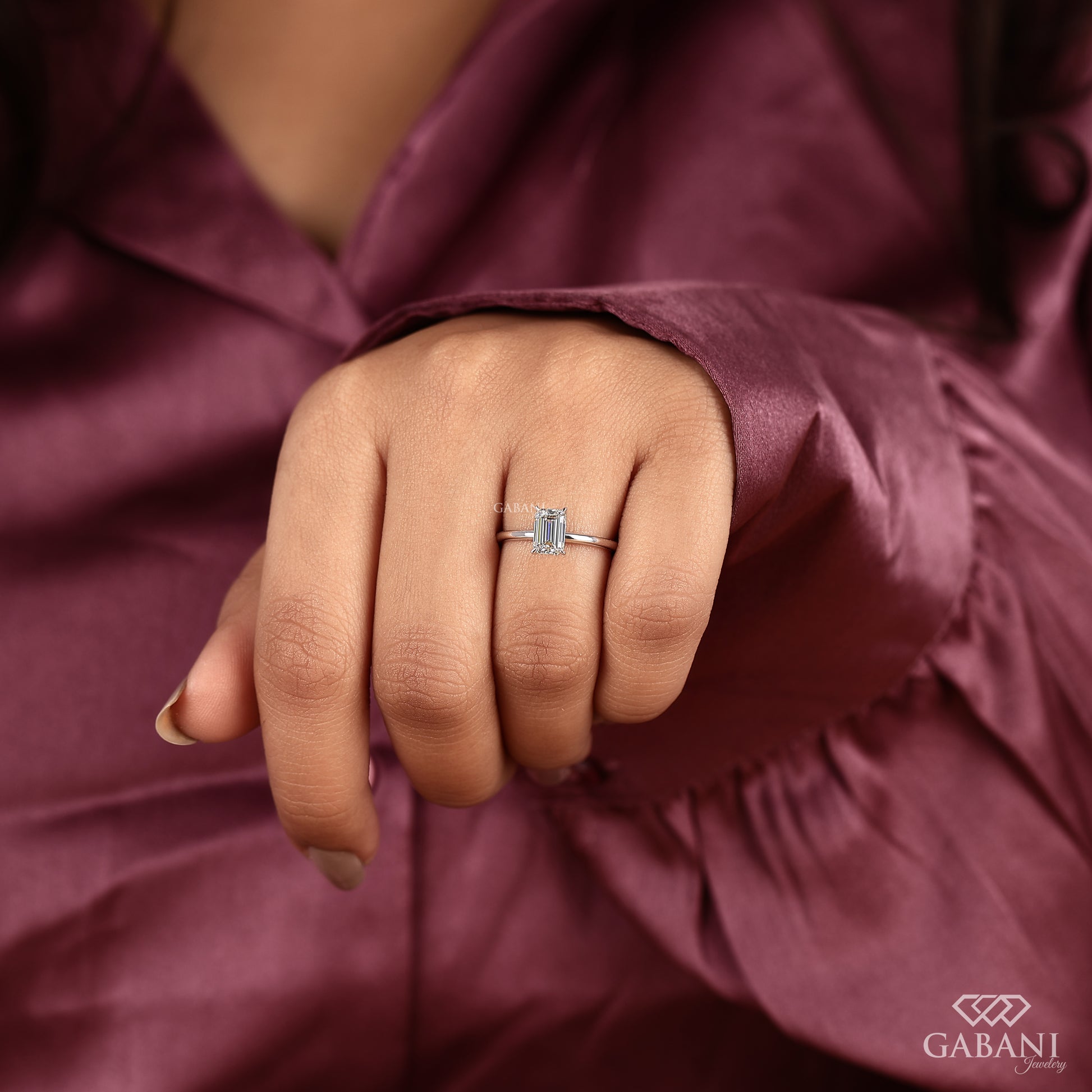 dainty emerald cut lab grown diamond ring in white gold with clean solitaire design