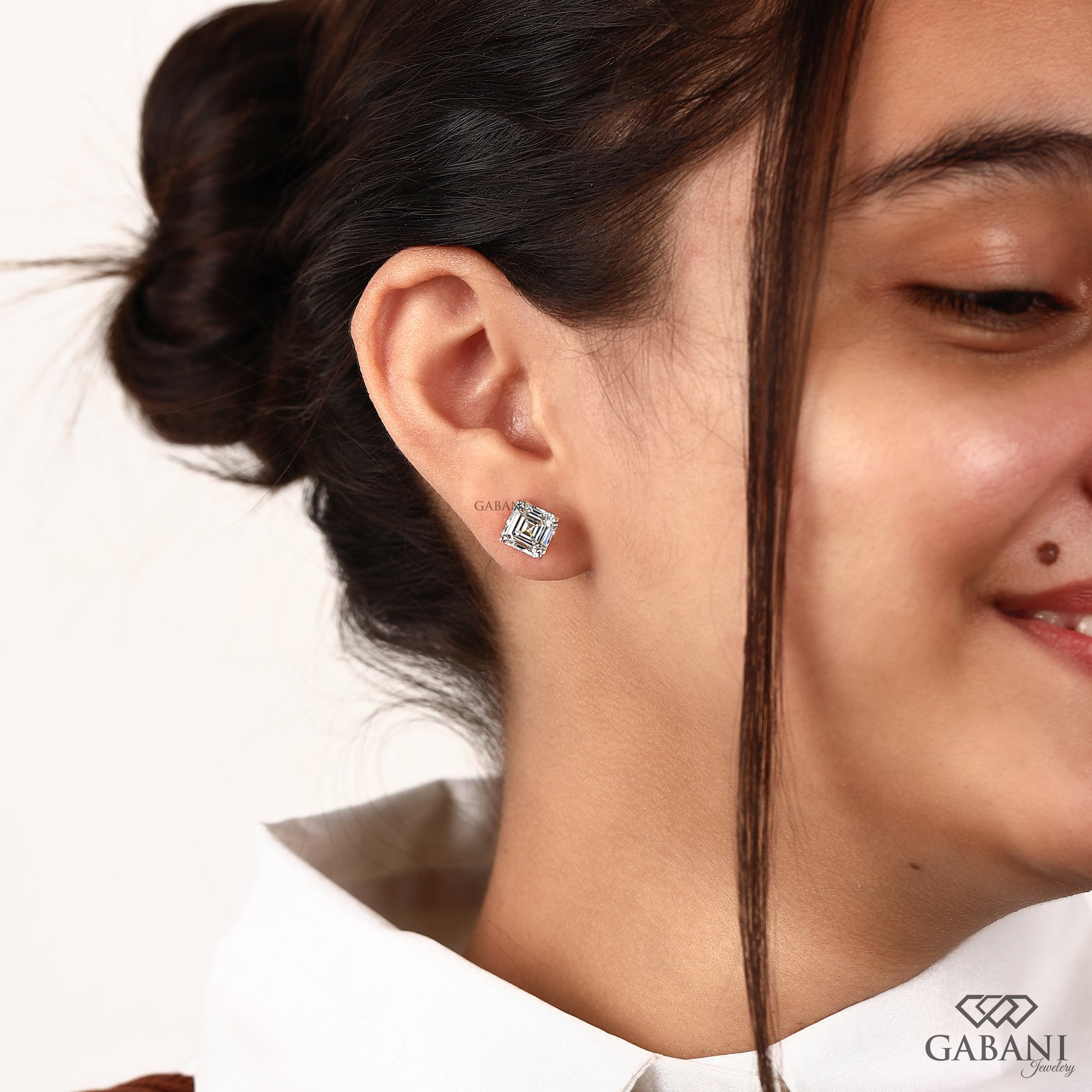 Yellow gold Asscher cut diamond studs featuring lab grown diamonds and button prong design