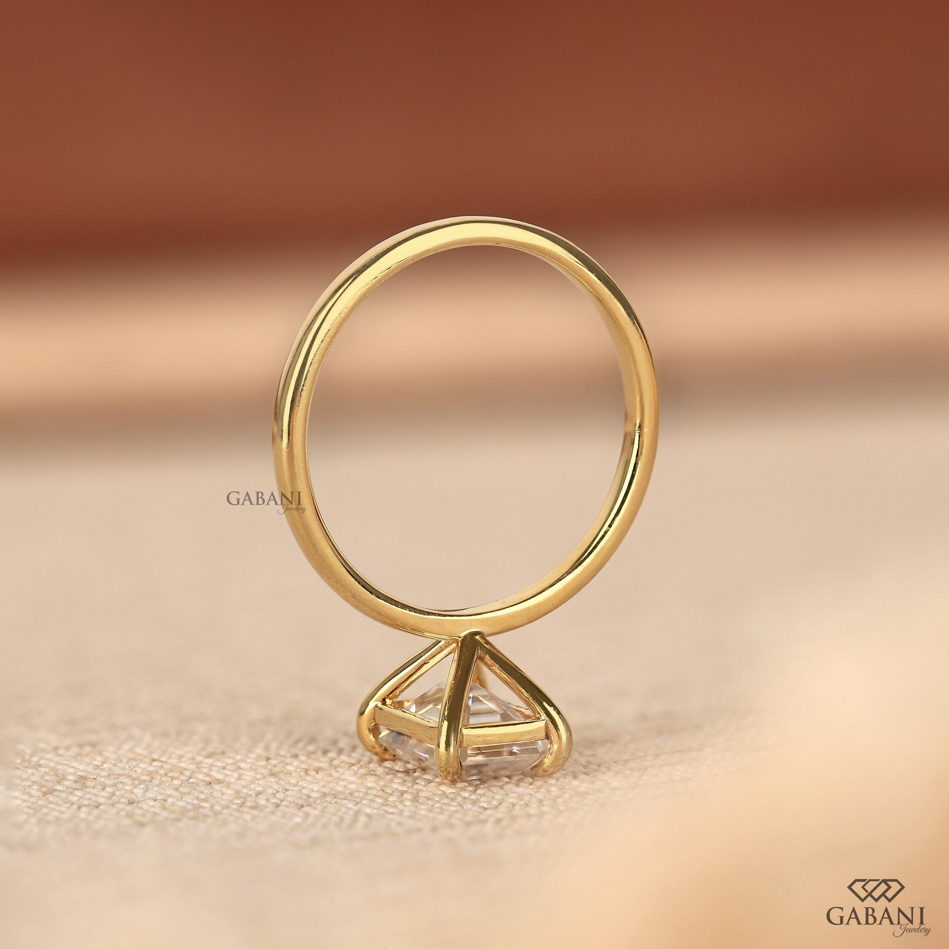 Step cut emerald lab grown diamond solitaire ring yellow gold
