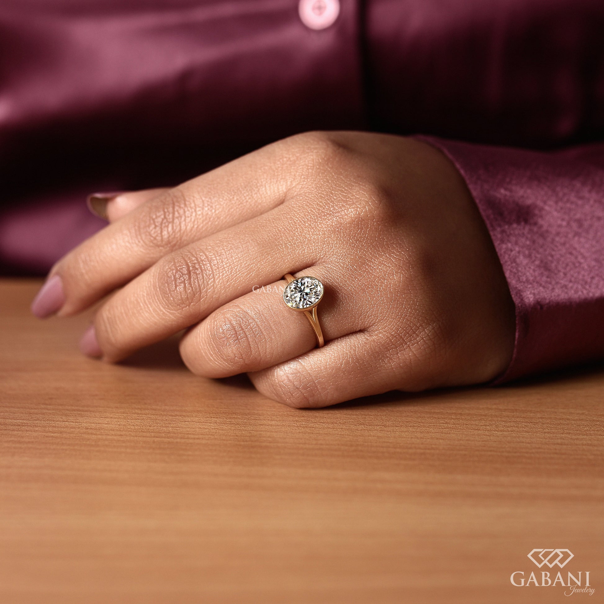 Bezel set oval lab grown diamond engagement style ring in gold