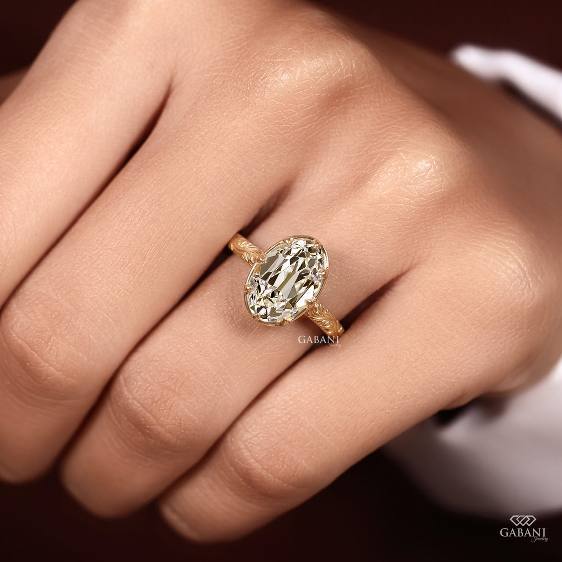 Oval old mine cut lab grown diamond engagement ring in 18K yellow gold with a vintage engraved band and antique-inspired detailing.
