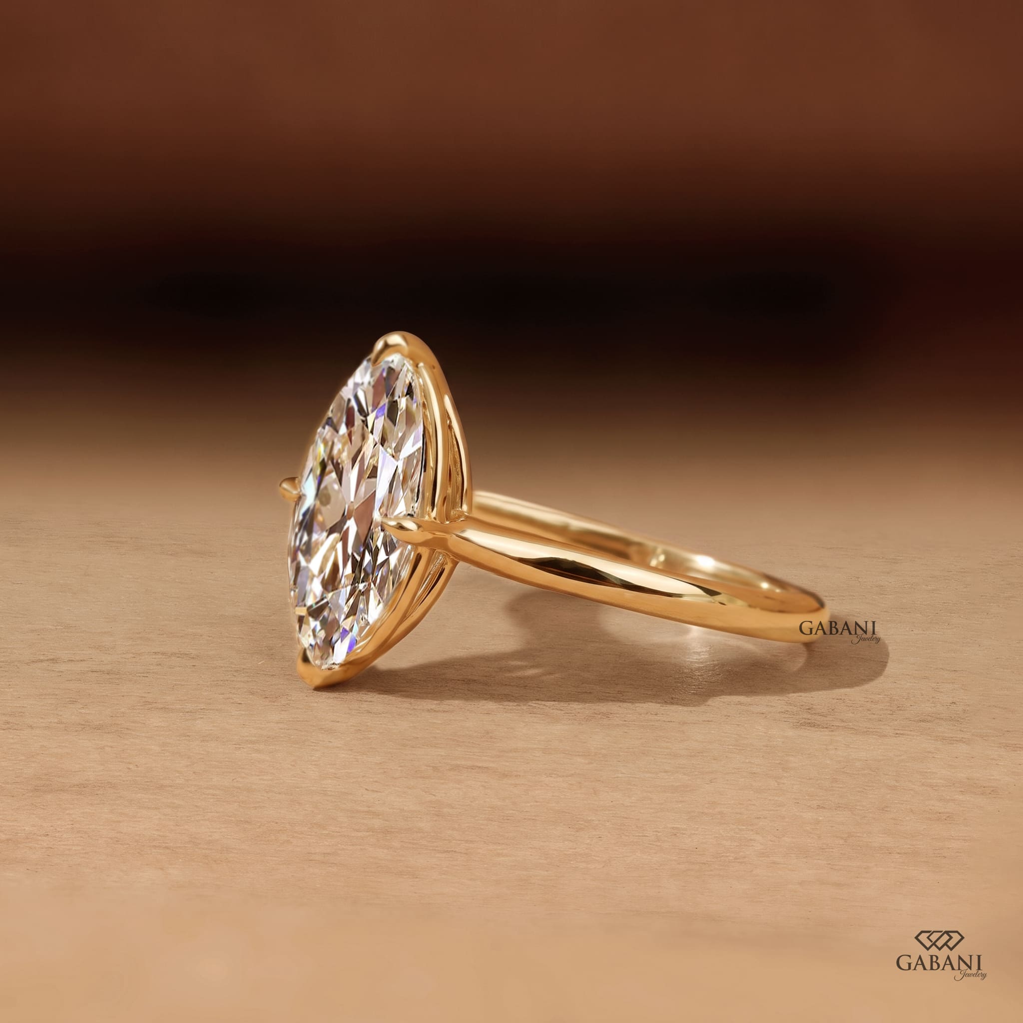 Oval old mine cut lab grown diamond engagement ring in 18K yellow gold with antique-style faceting, claw prong setting and polished solitaire band.