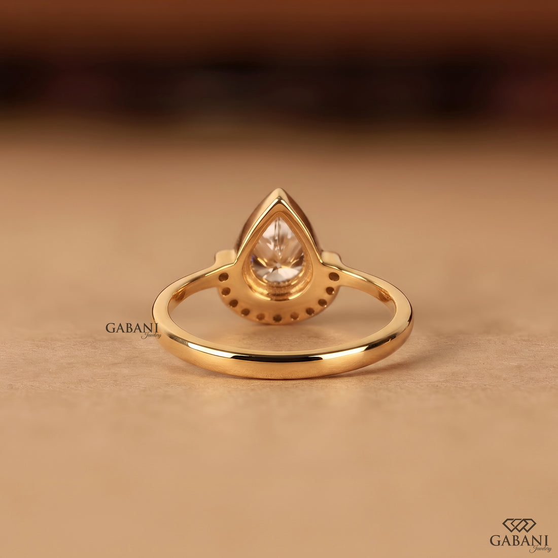 IGI certified lab grown diamond pear cut engagement ring in yellow gold