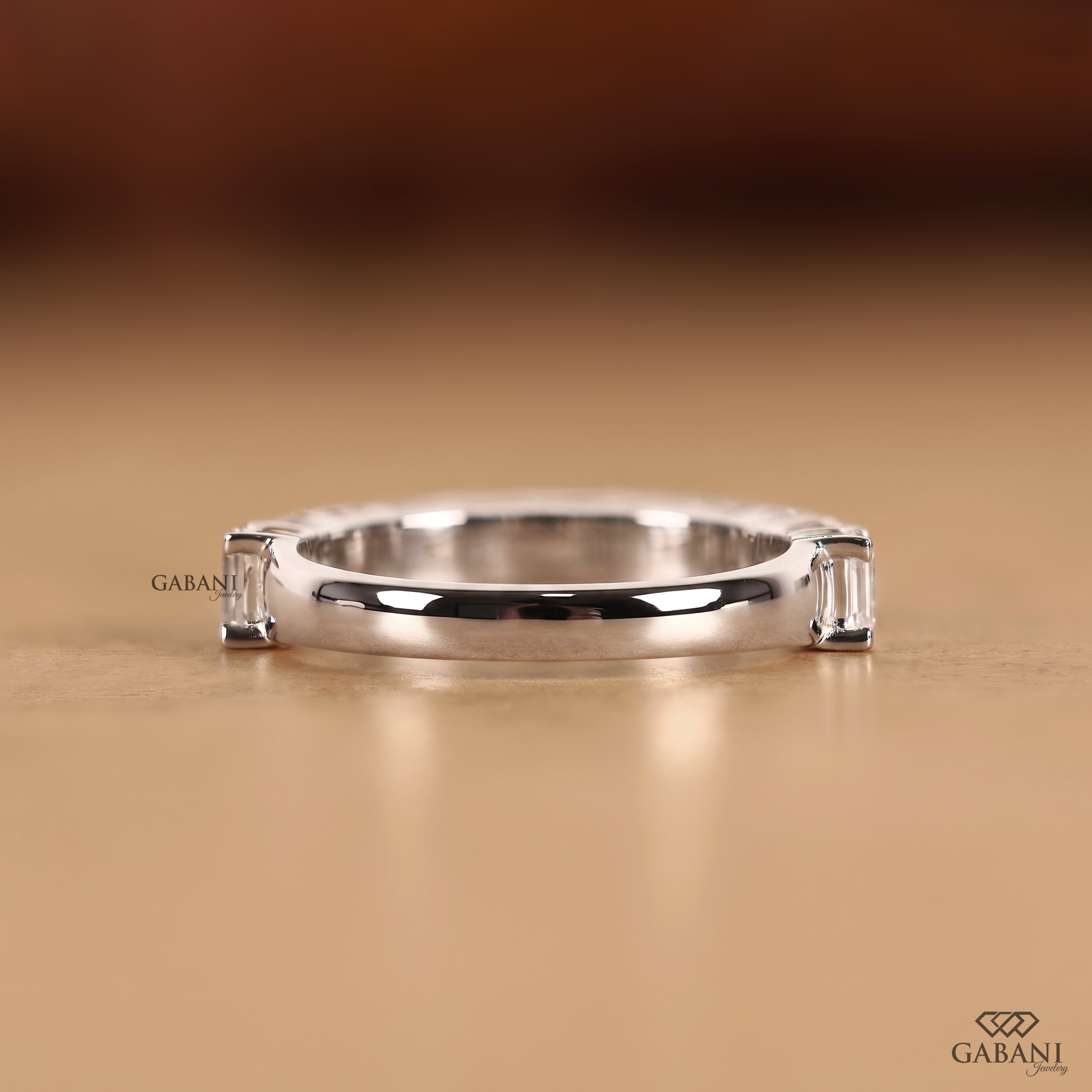 Back view of an emerald cut lab grown diamond matching wedding band with a refined half eternity design