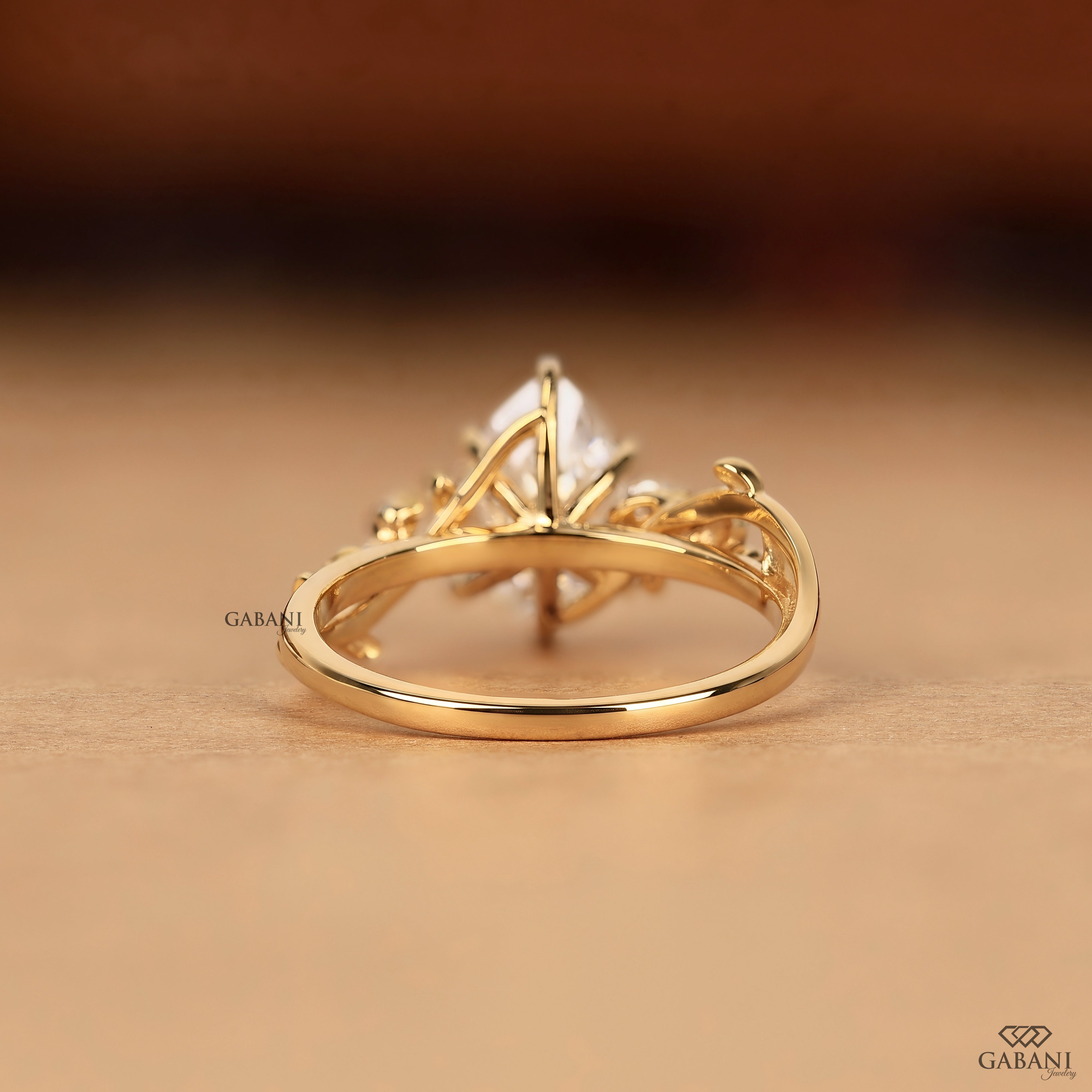 Back view of pear cut lab grown diamond leaf style engagement ring with solid gold design