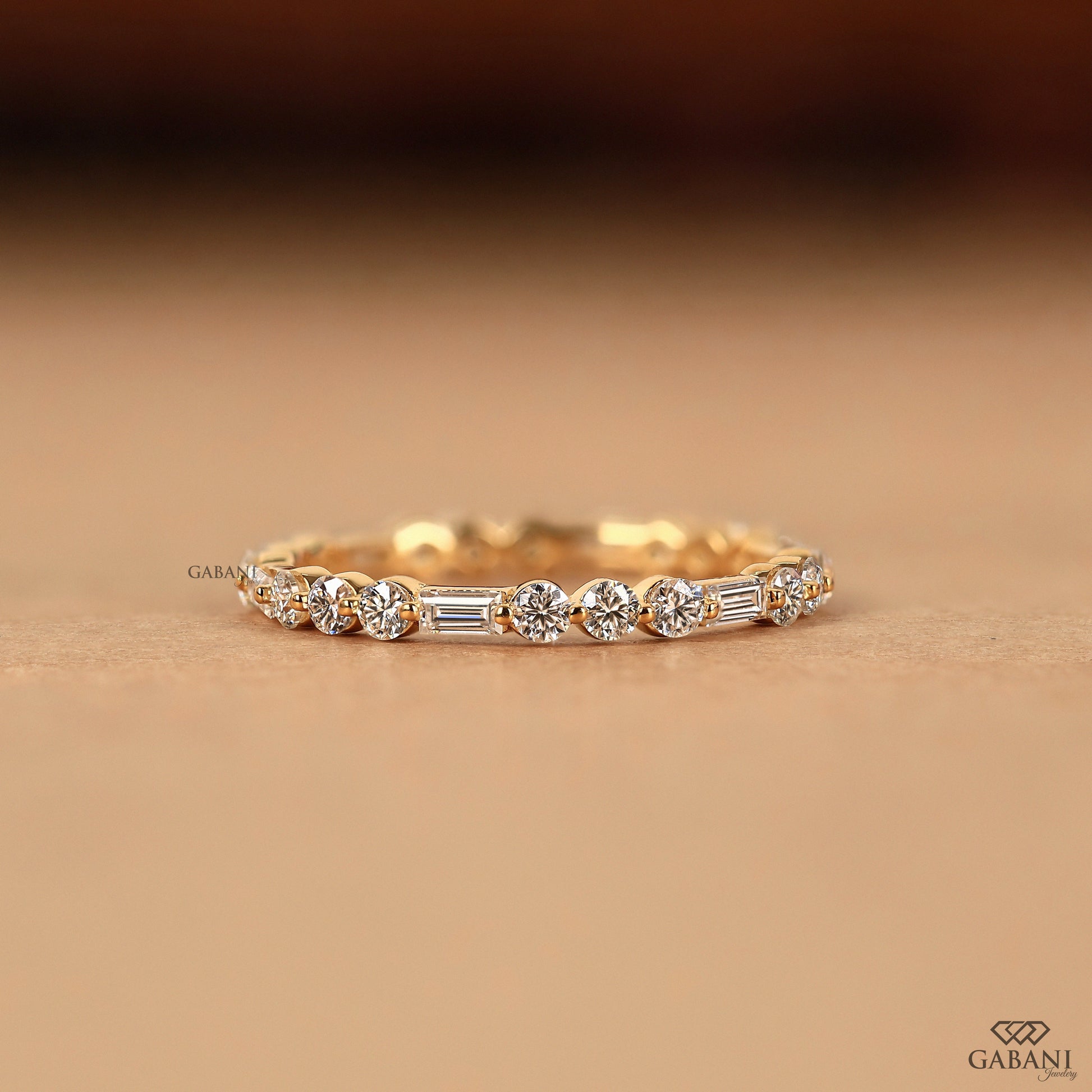 lab grown diamond eternity band with baguette and round stones in 14k yellow gold thin band