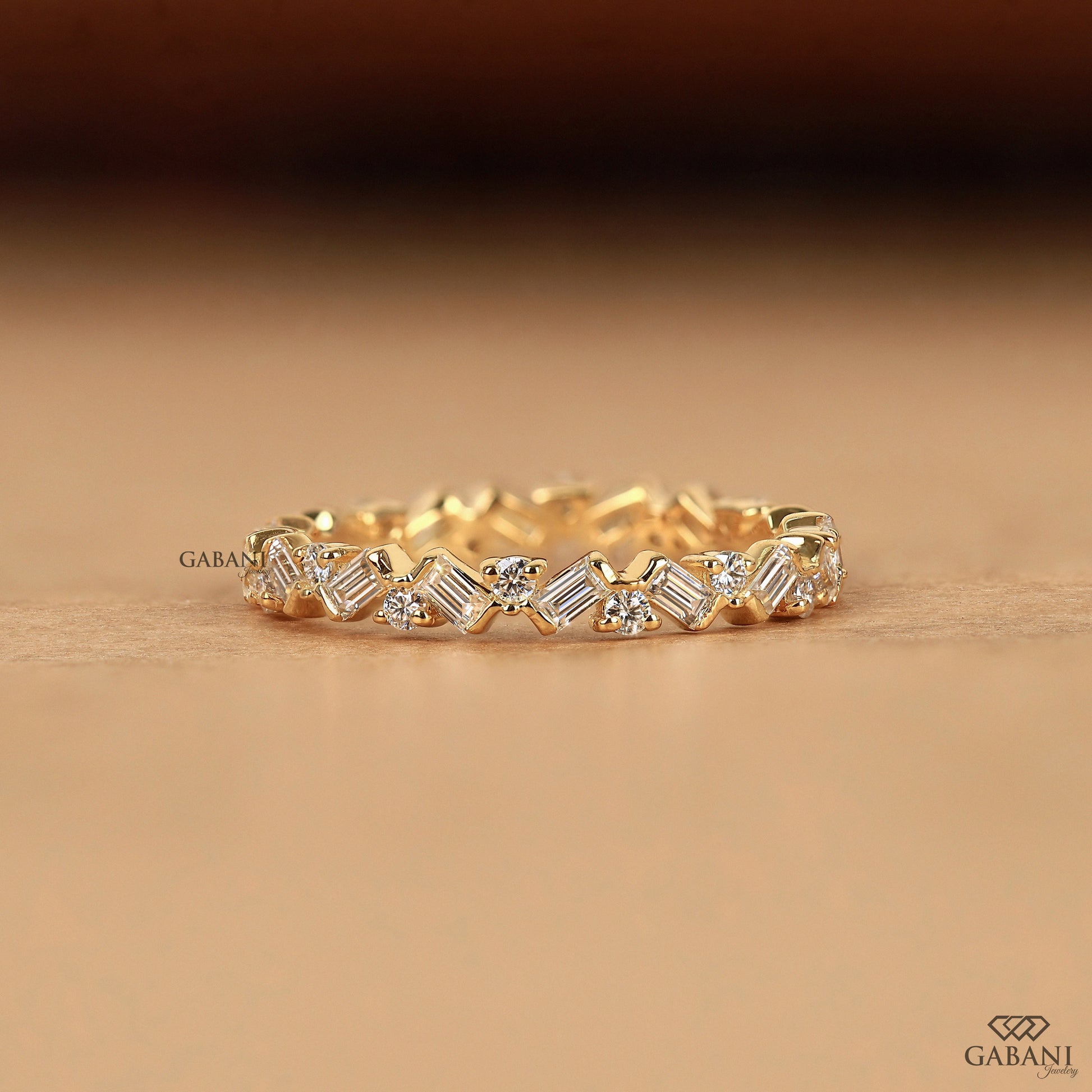 Gabani Jewelry baguette and round lab diamond eternity band in yellow gold