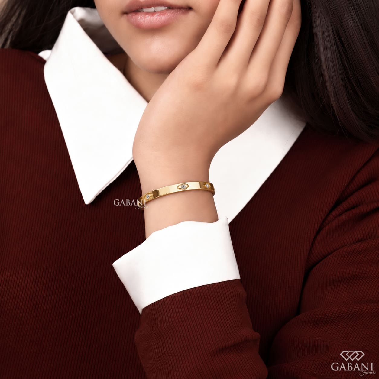 a round lab grown diamond station bangle bracelet in yellow gold, featuring evenly spaced round diamonds in polished bezel-style settings.