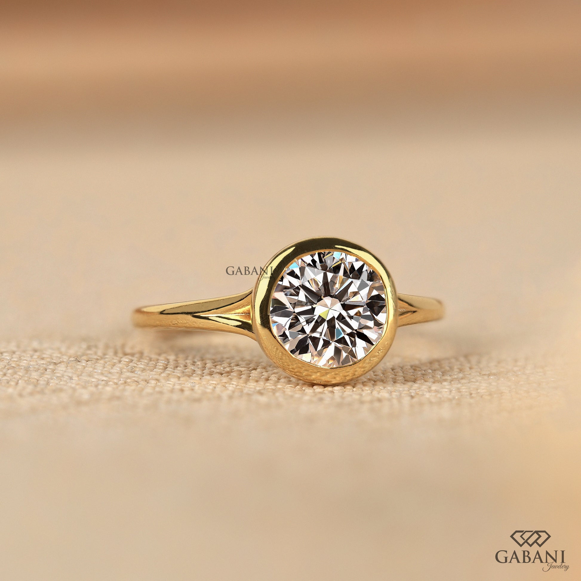 Yellow gold round lab grown diamond ring with secure bezel setting