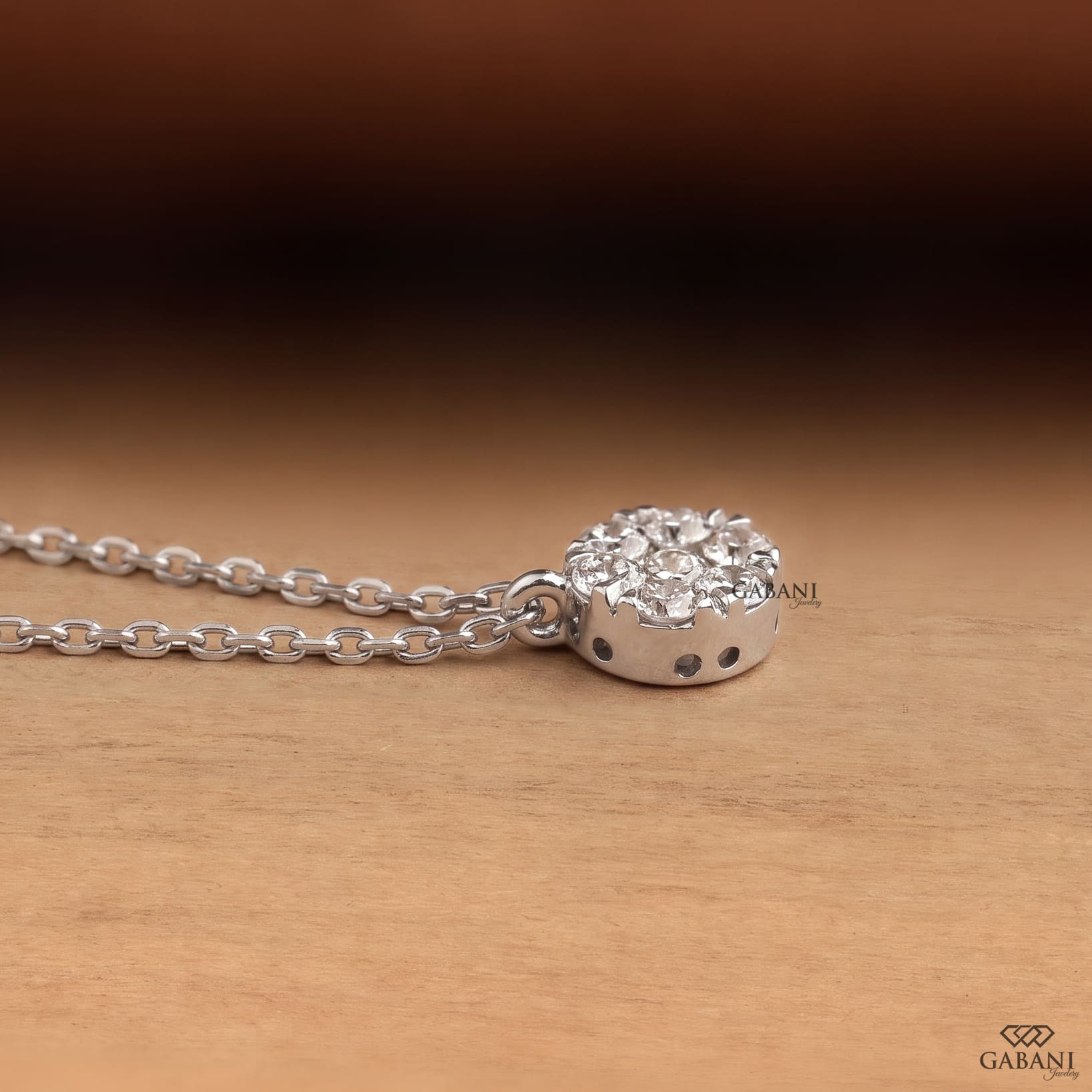 Seven stone round cut lab grown diamond floral cluster necklace in 18K white gold with a delicate cable chain and prong setting.
