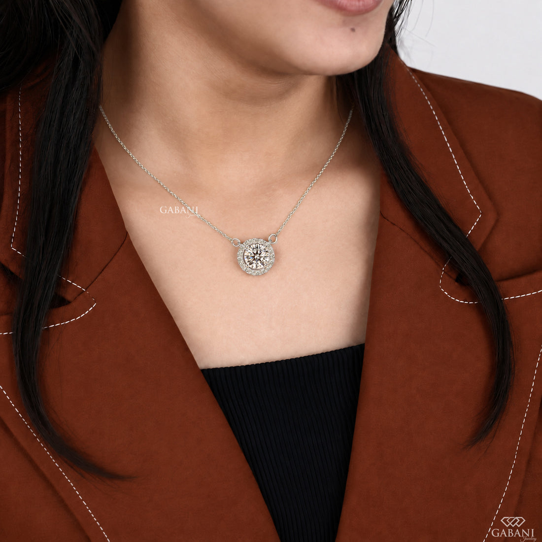 Round cut lab grown diamond floating halo pendant in white gold with a four prong center setting and circular pavé diamond halo.