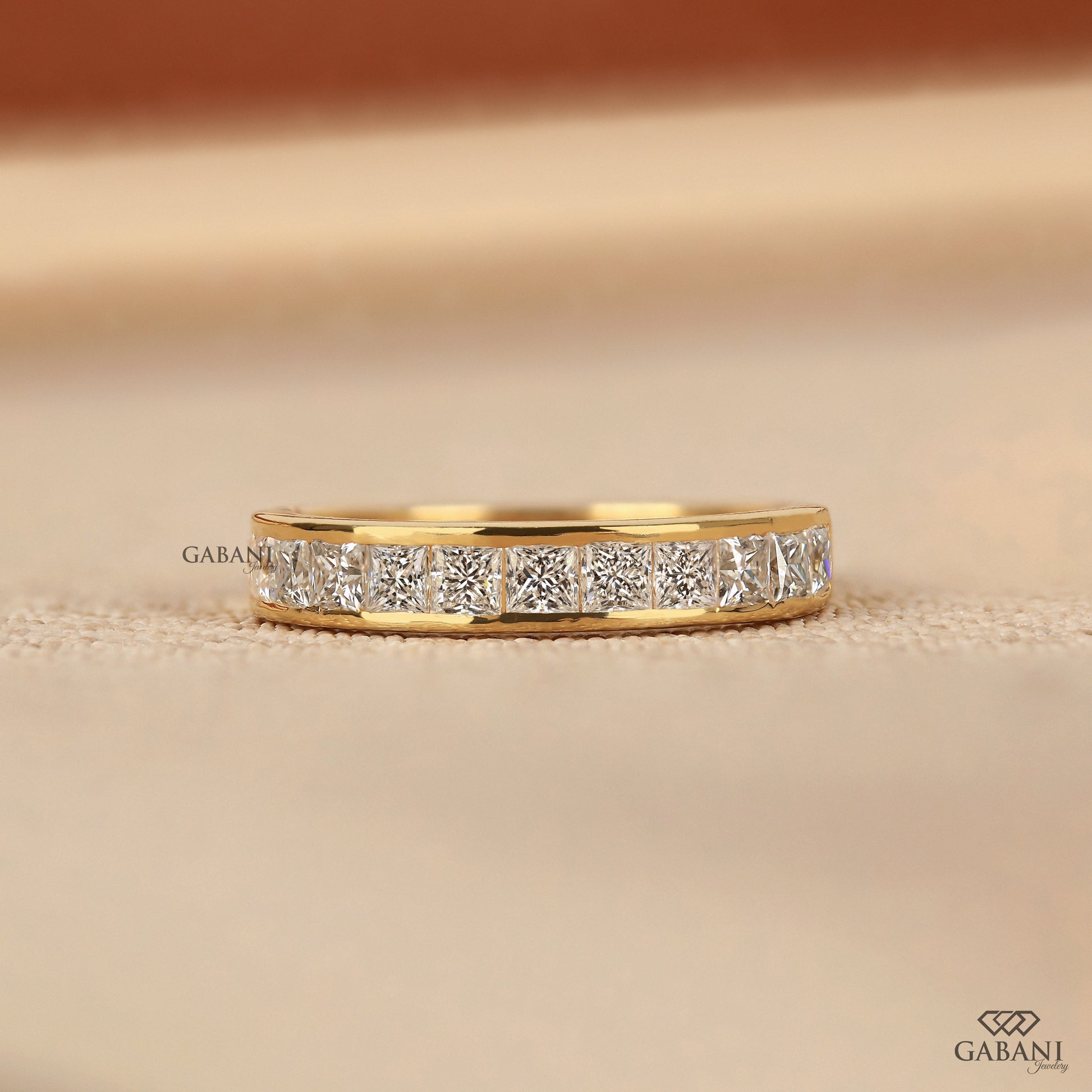 Channel set half eternity band with princess cut lab grown diamonds in 14K yellow gold