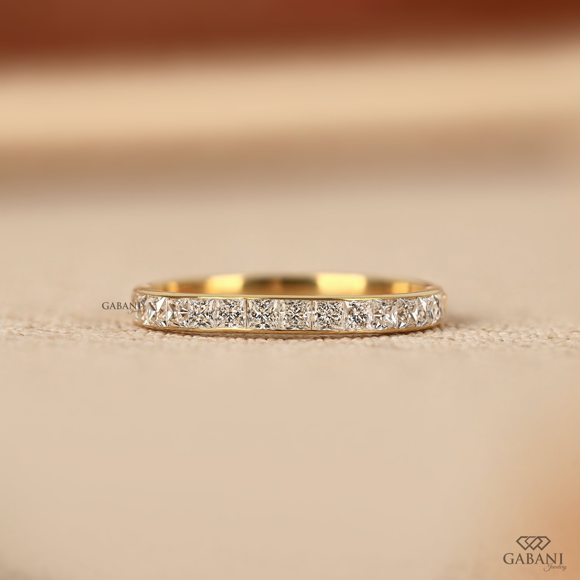princess cut lab grown diamond wedding band in yellow gold with channel set half eternity design