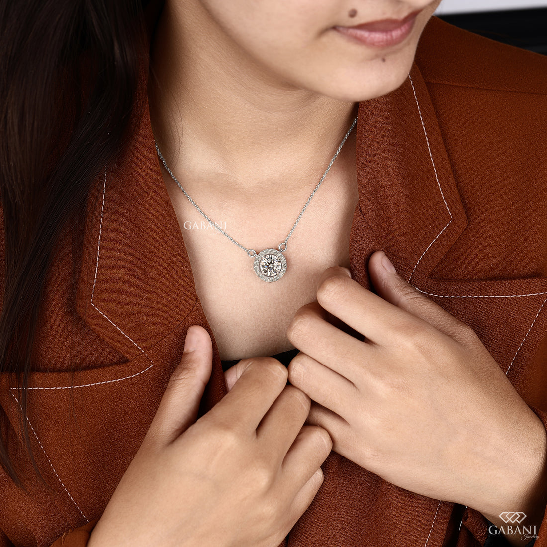 Round cut lab grown diamond floating halo pendant in white gold with a four prong center setting and circular pavé diamond halo.