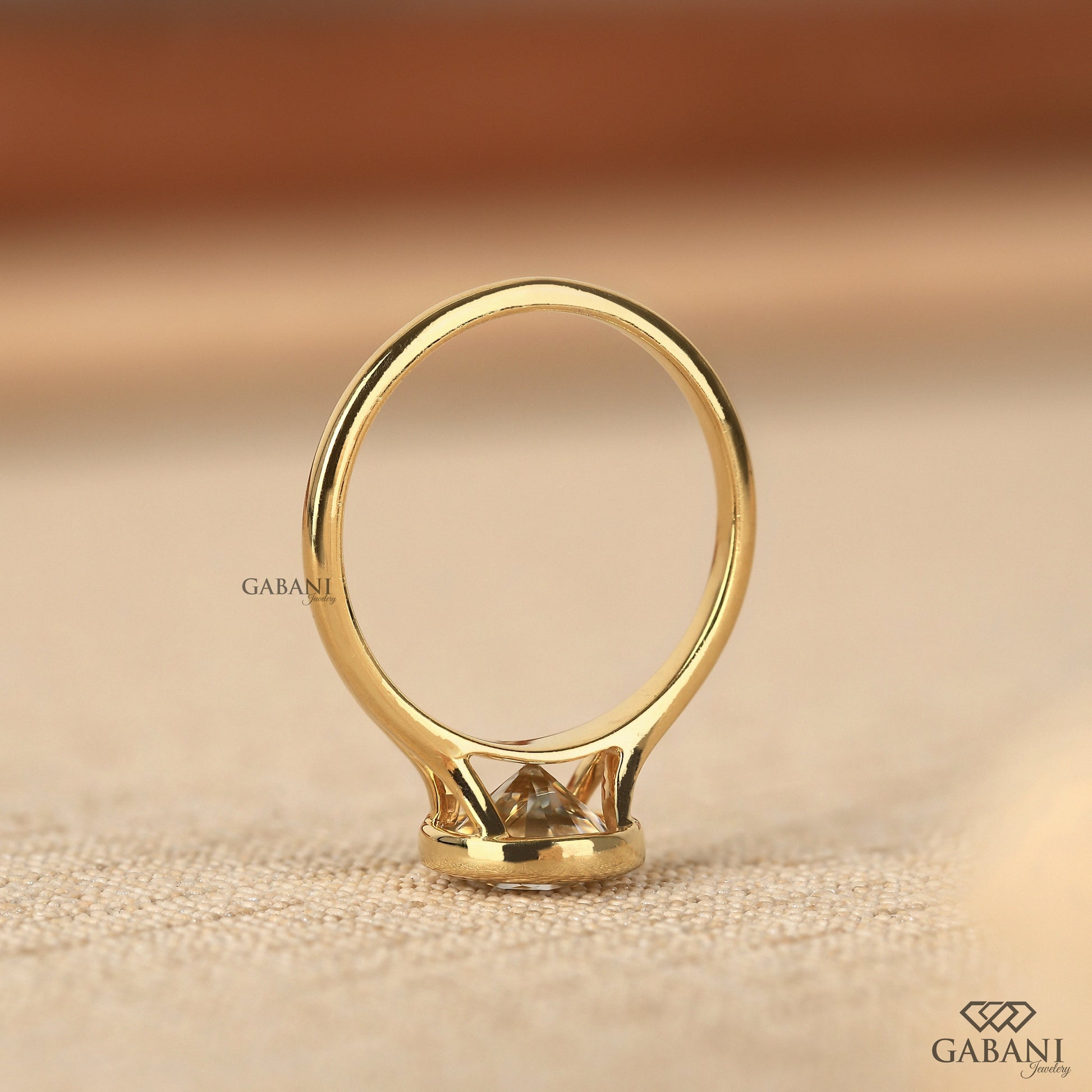 Modern bezel set round lab grown diamond solitaire ring in yellow gold