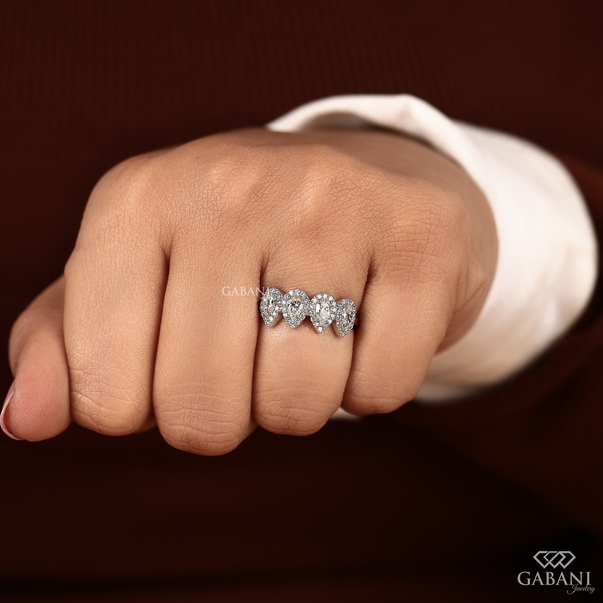 halo style wedding band with four pear diamonds