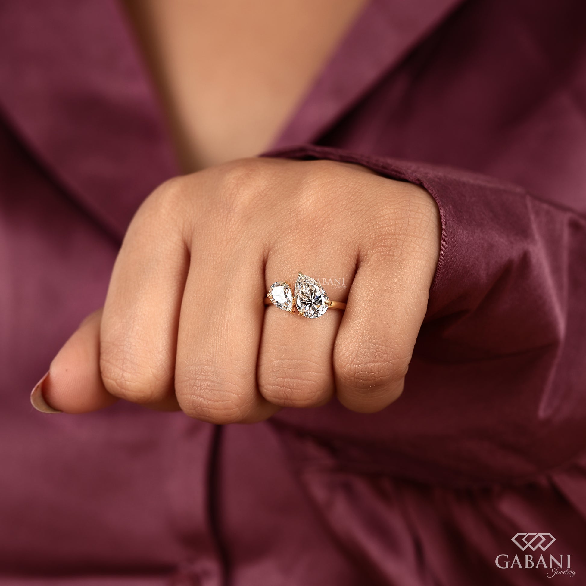 you and me ring with contrasting pear cut lab grown diamonds in a modern yellow gold design