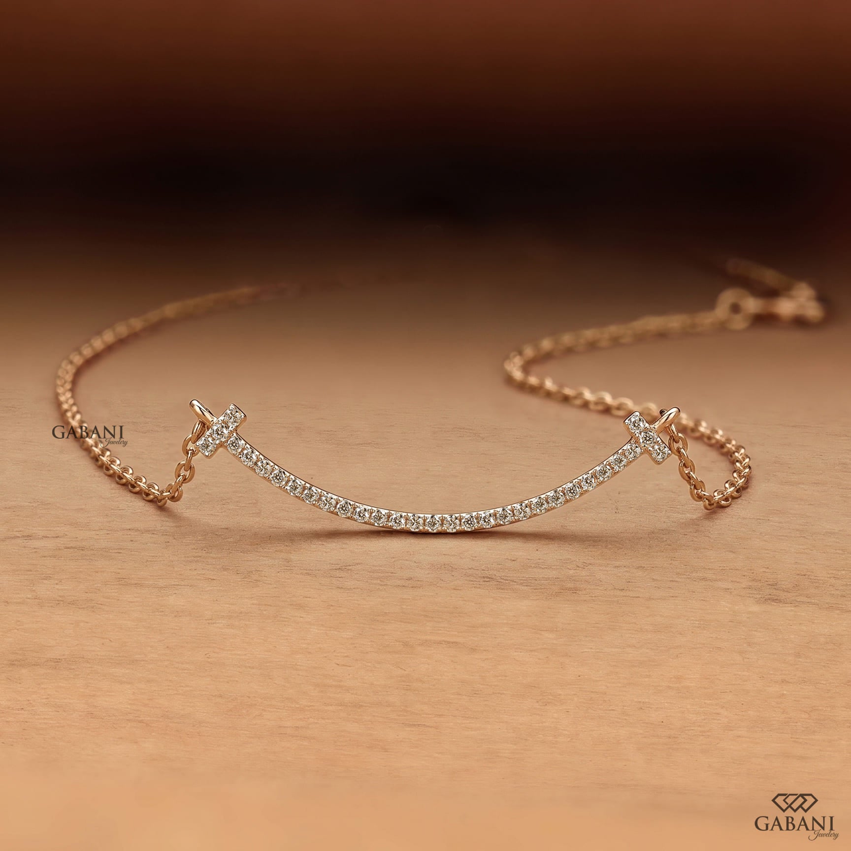 Curved bar lab grown diamond necklace in yellow gold featuring round pavé set diamonds, T-shaped ends and a delicate gold chain.