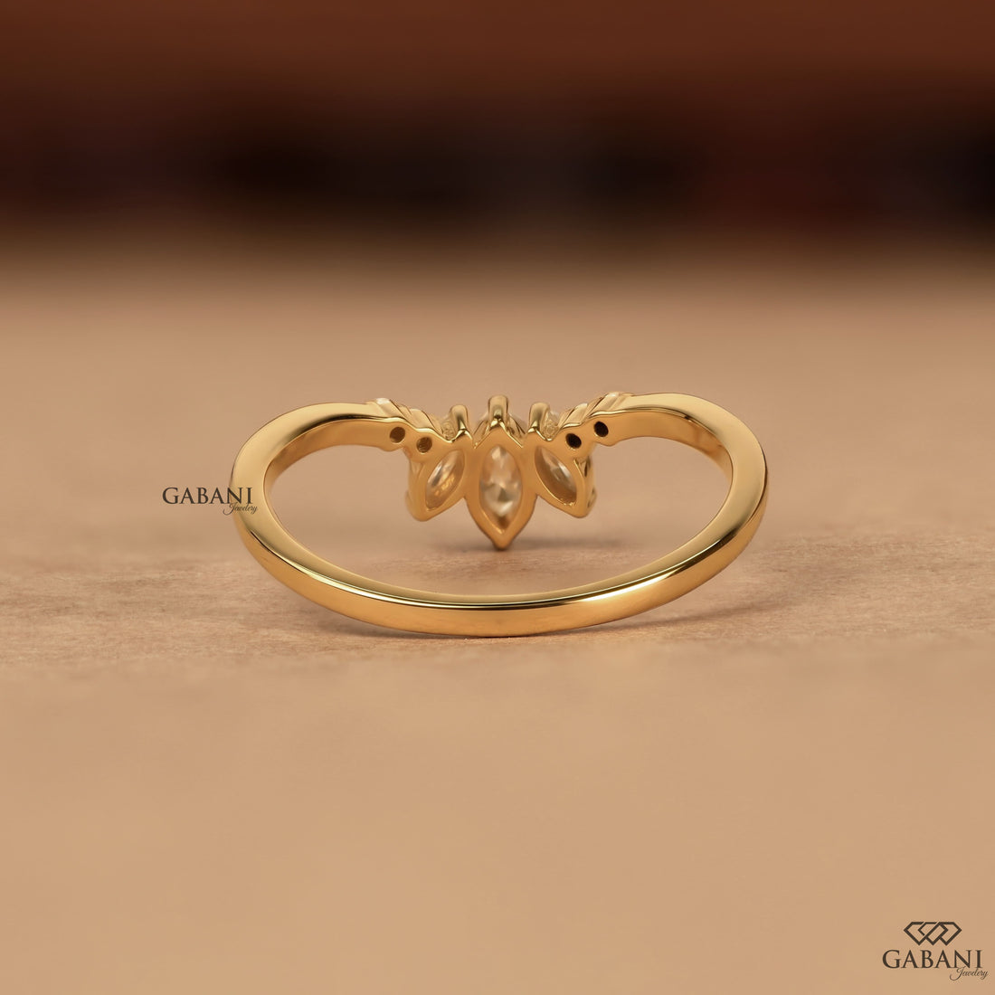 Marquise and round cut lab grown diamond curved wedding band in 14K yellow gold with a contour design, ideal for stacking with an engagement ring.