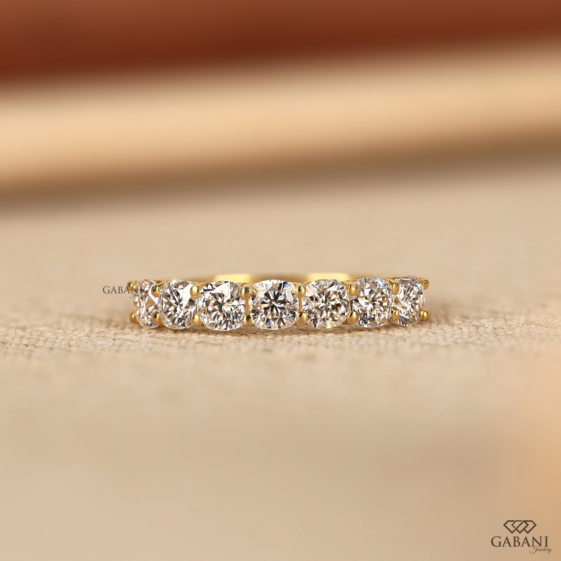 7 cushion cut lab created diamond band in a slim yellow gold design with a clean u prong setting