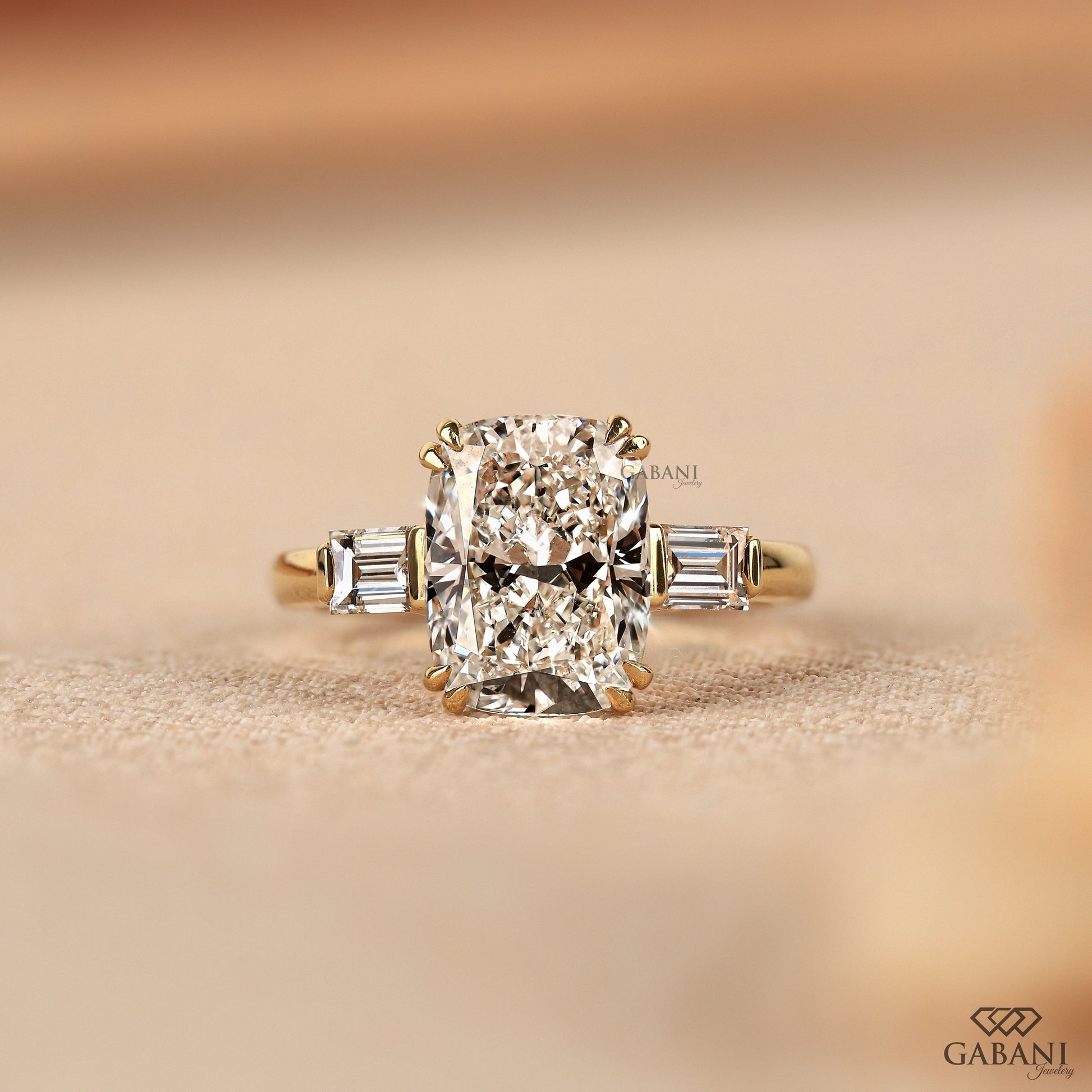 Elongated cushion cut lab grown diamond three stone engagement ring in solid yellow gold