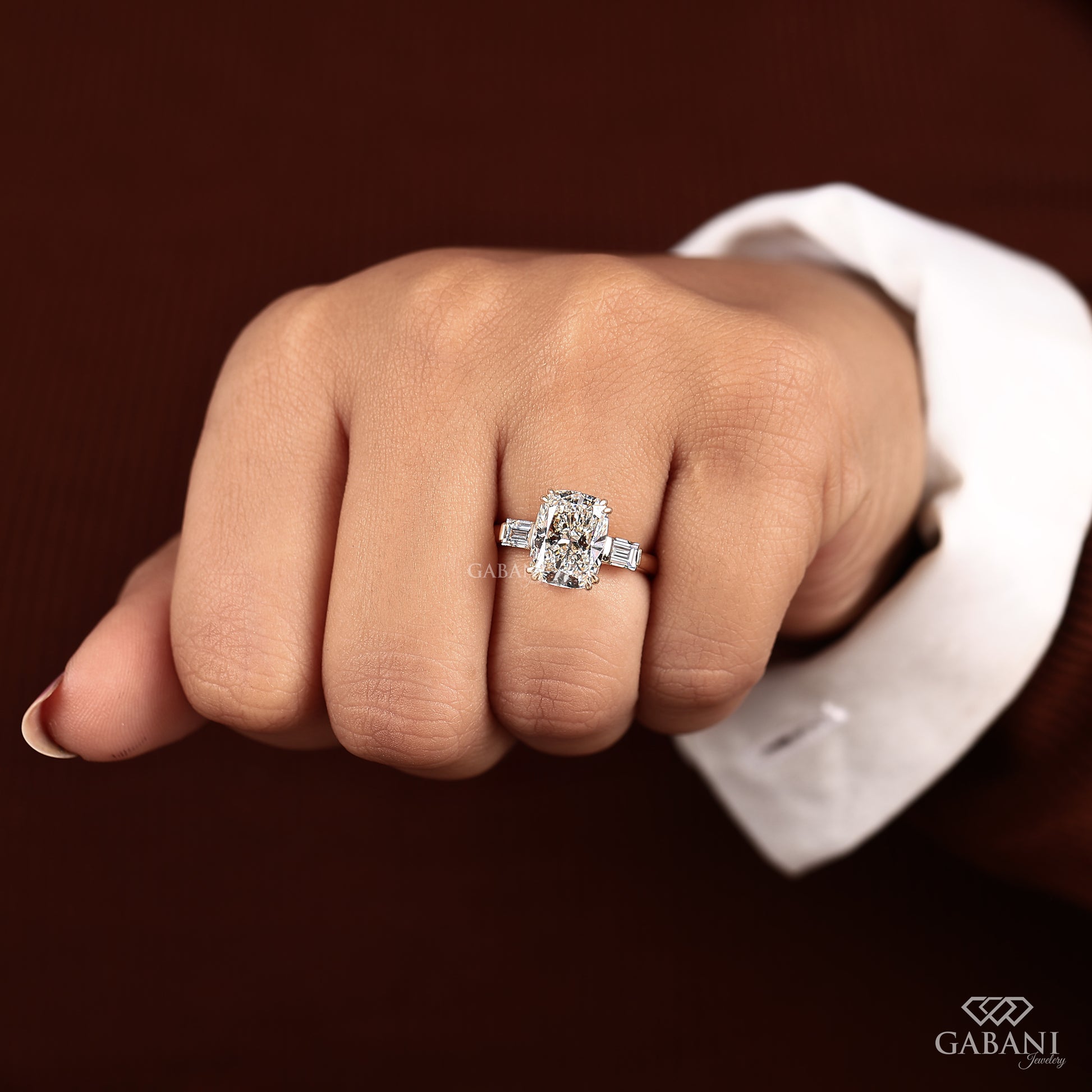 Handmade elongated cushion cut diamond engagement ring with three stone design