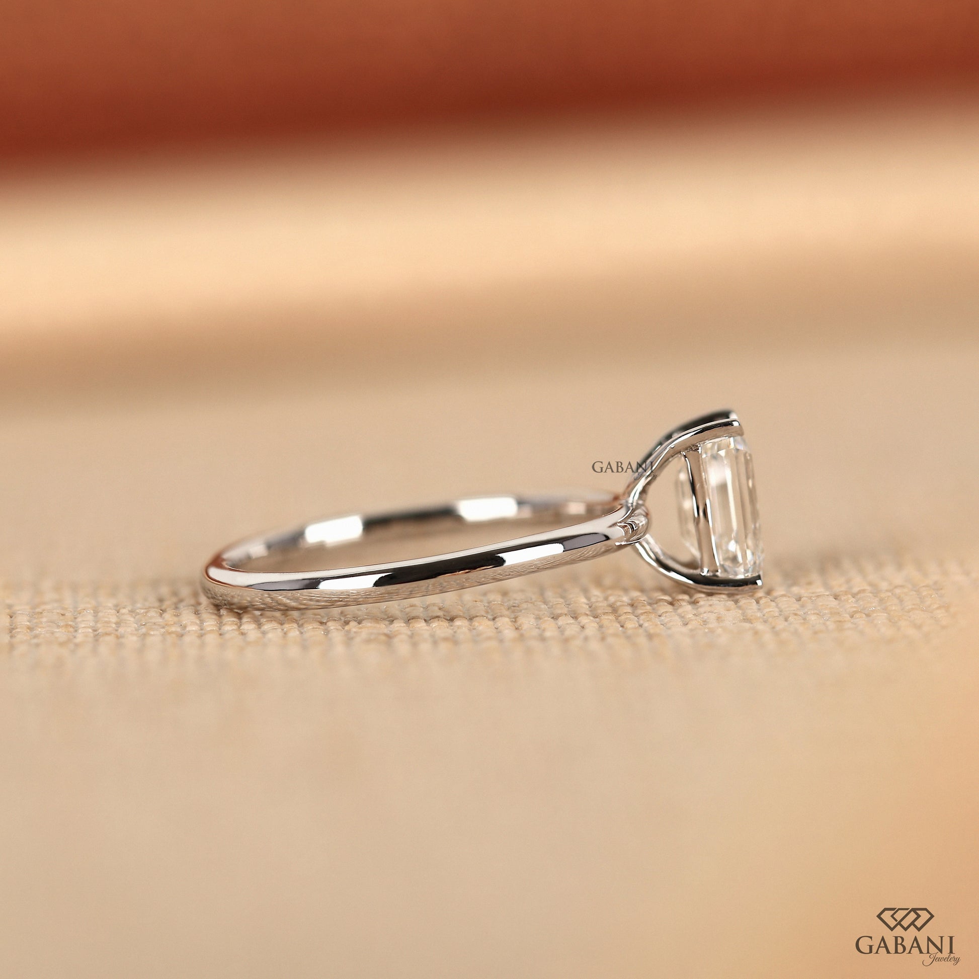 white gold emerald cut lab grown diamond ring with flat basket setting