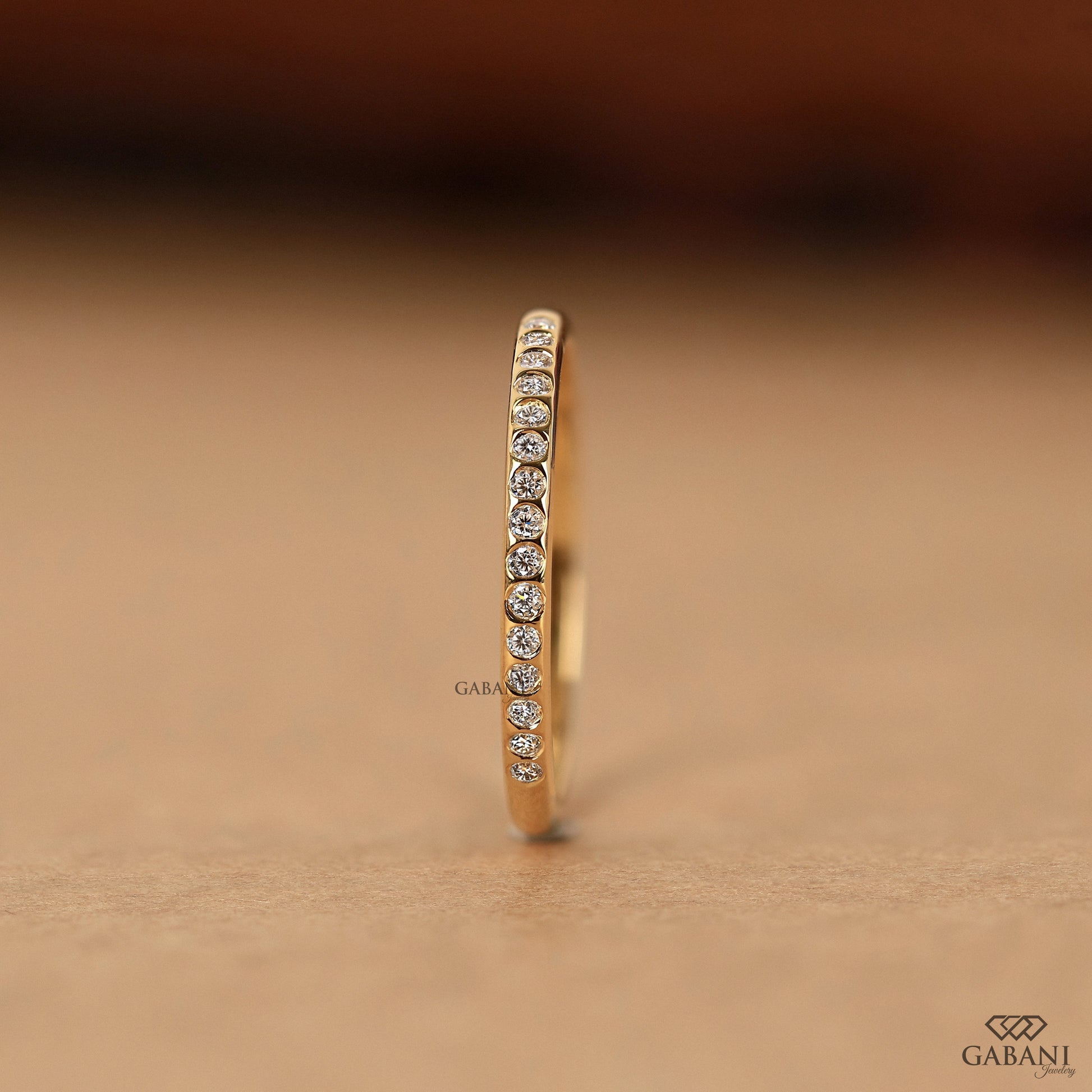 dainty gold half eternity ring with flush set lab diamonds and smooth finish