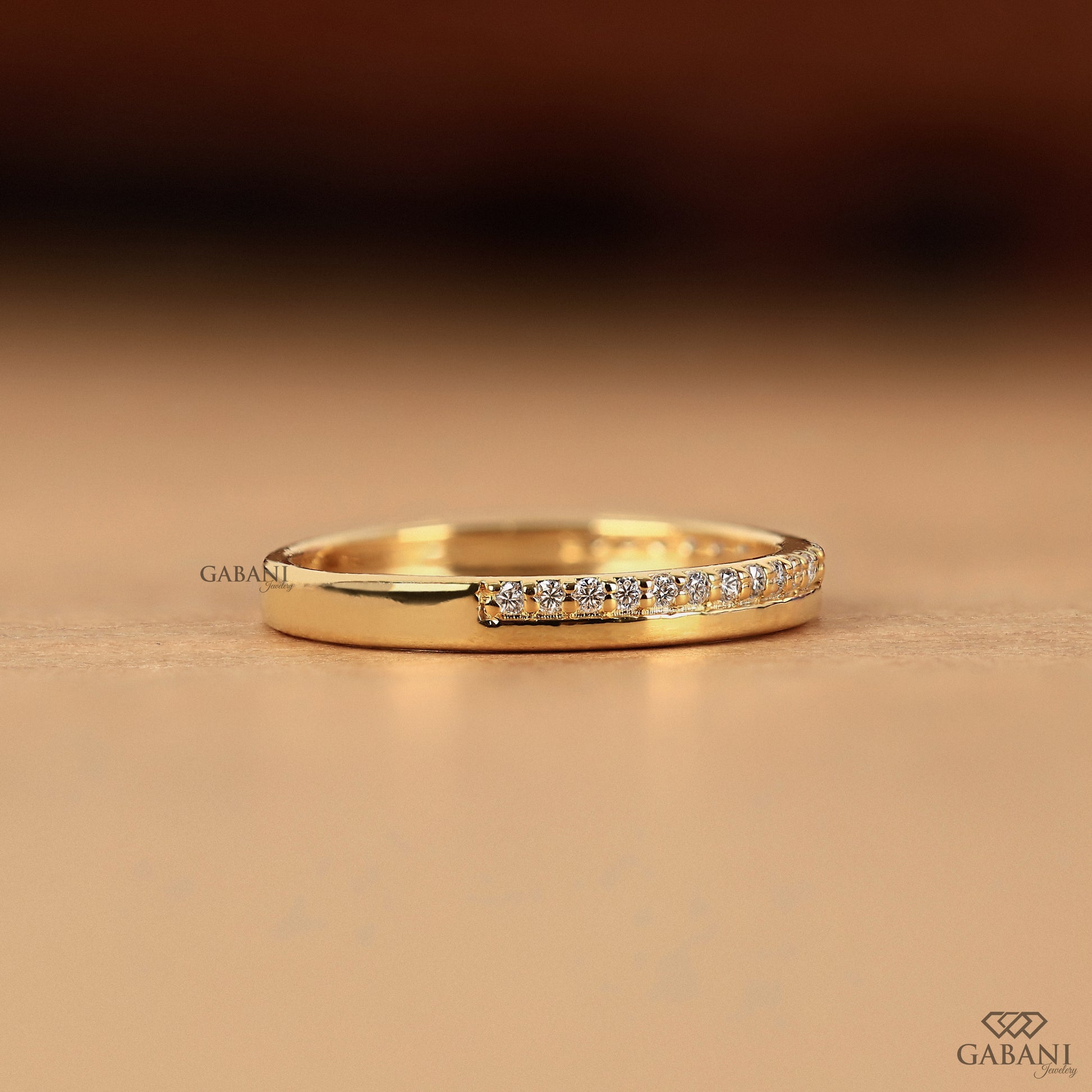 lab grown diamond wedding band with one side pave in gold