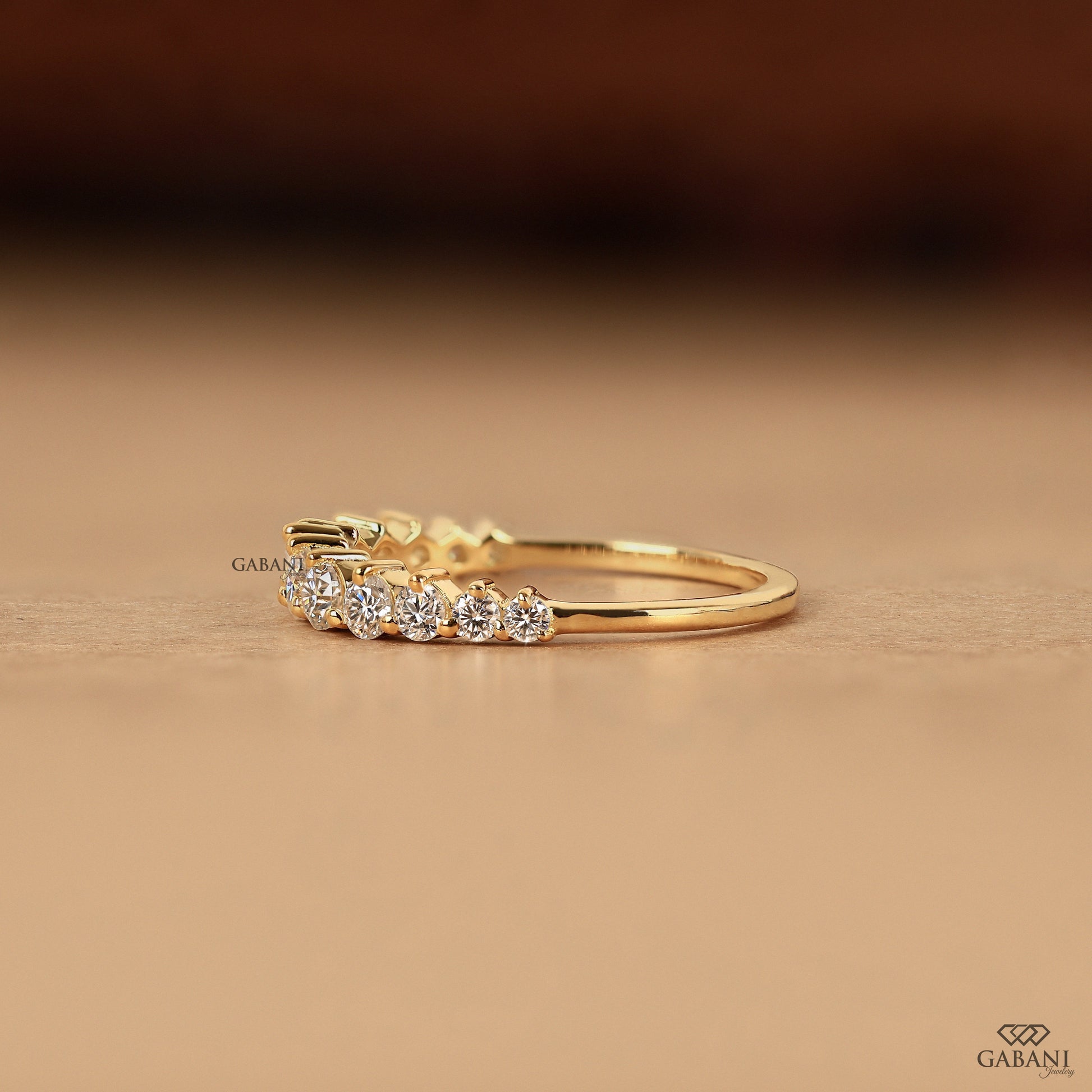 minimal yellow gold band with small round lab diamonds in half eternity design