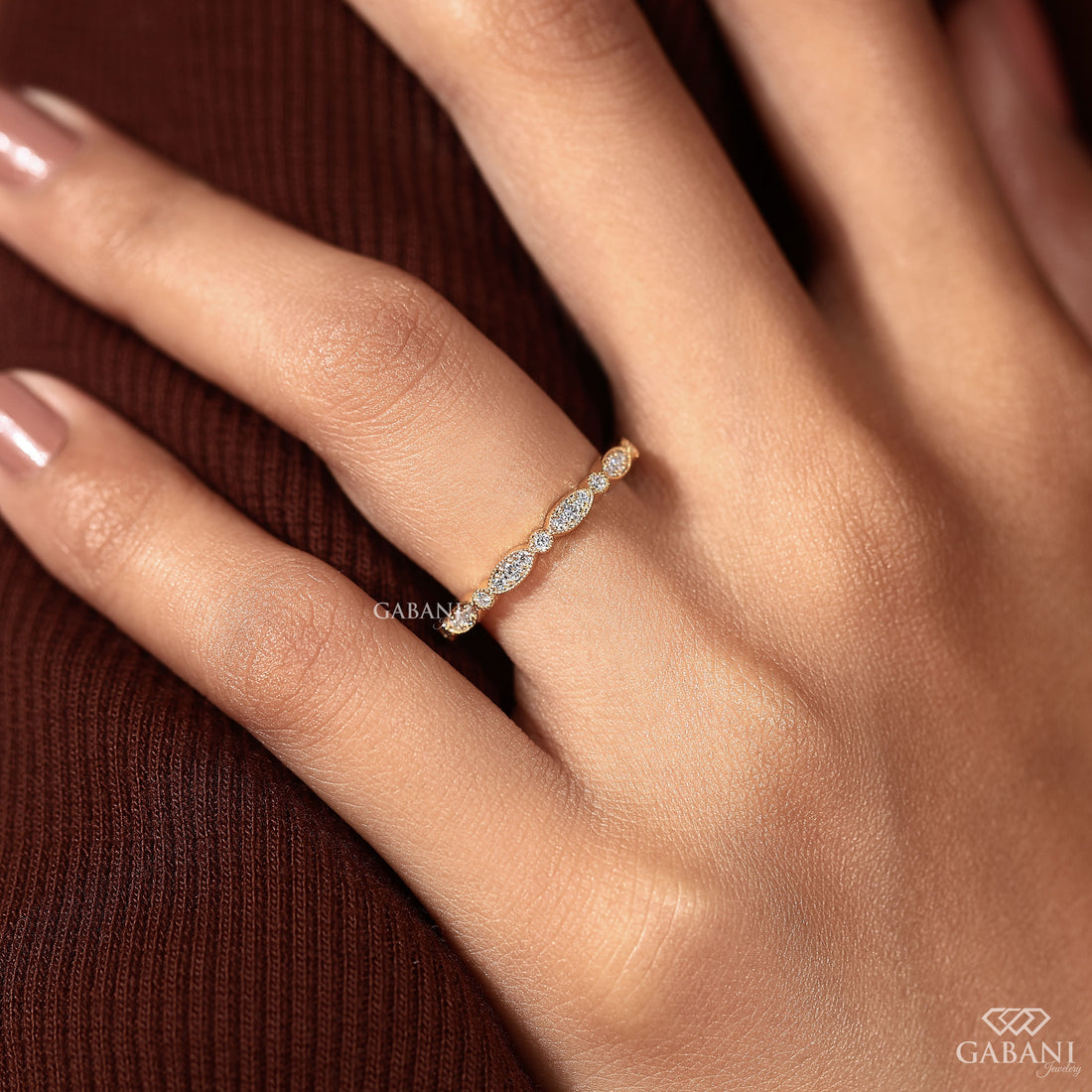 a round cut lab grown diamond wedding band in 14K yellow gold, featuring marquise-inspired diamond clusters, delicate milgrain detailing and a vintage design by Gabani Jewelry.