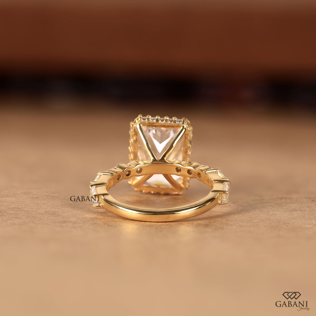 Radiant cut lab grown diamond engagement ring with hidden halo, round and baguette side diamonds, and polished gold band.