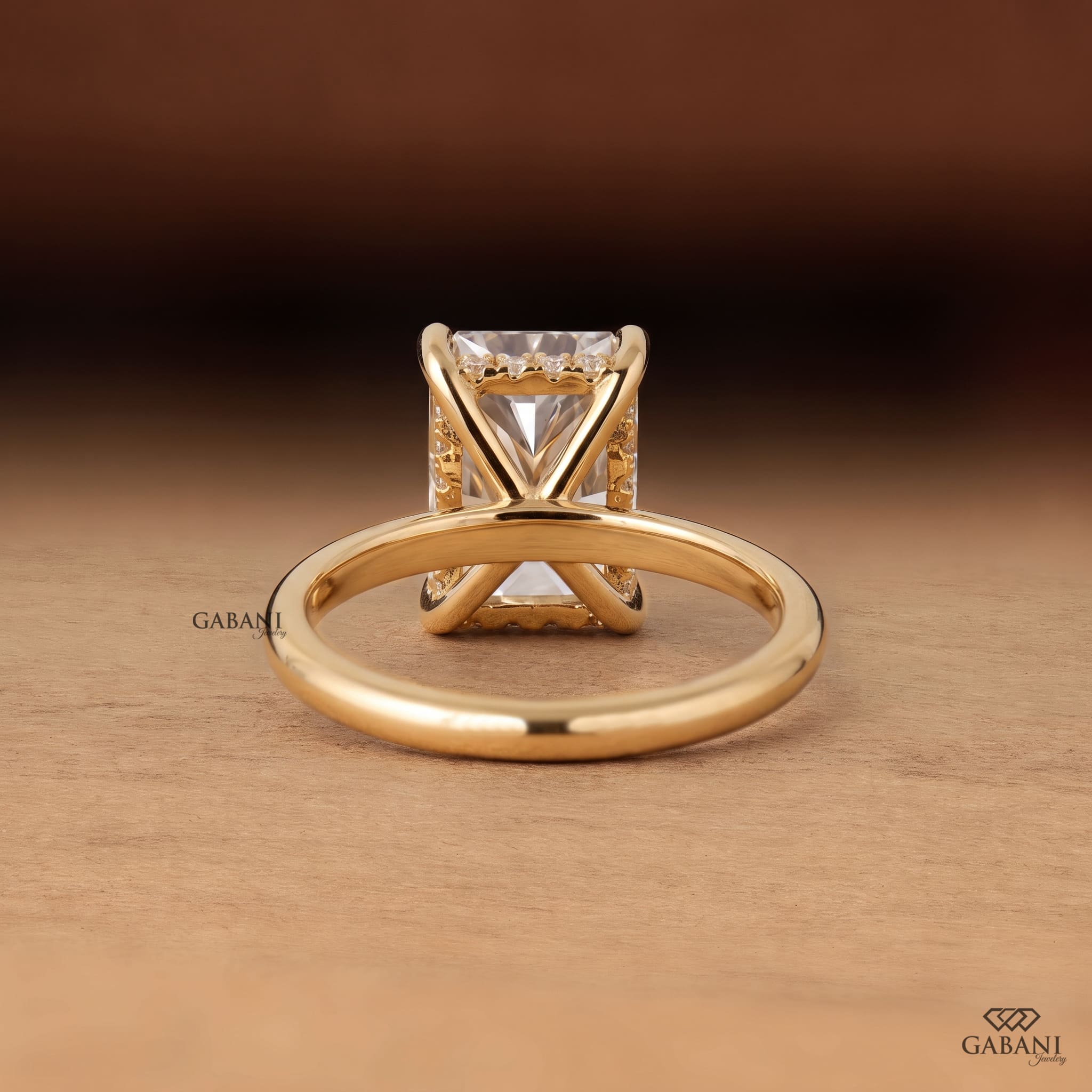 Radiant cut lab grown diamond engagement ring in 18K yellow gold with hidden halo, four claw prong setting and round diamond accents.