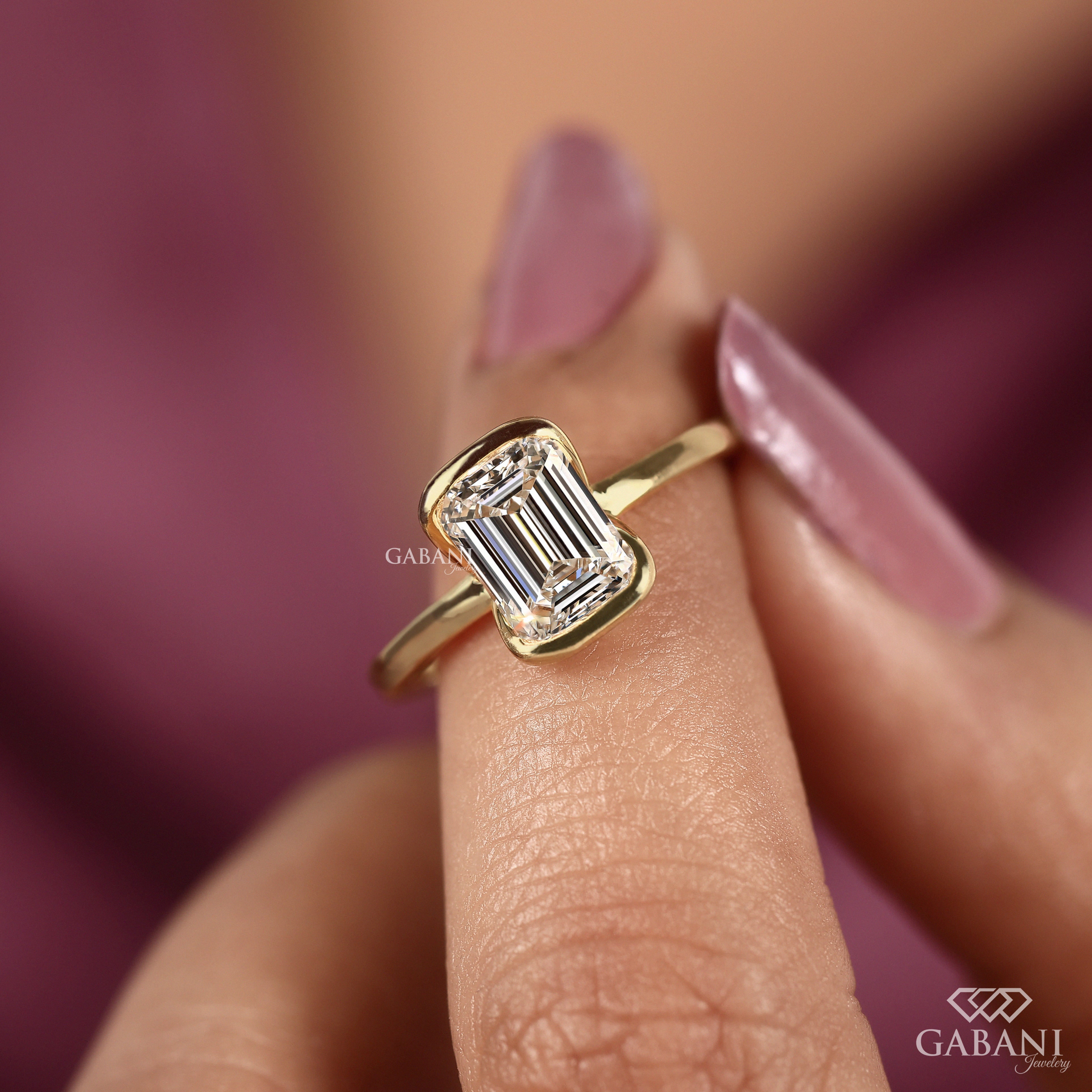 Front view of emerald cut lab grown diamond solitaire engagement ring with modern half bezel setting and polished 14K yellow gold band.