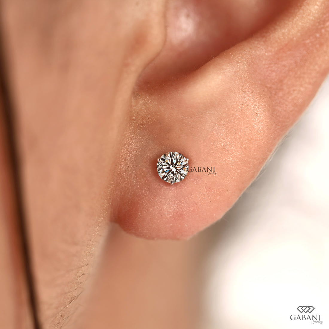 Round cut diamond stud earrings designed with a delicate prong setting