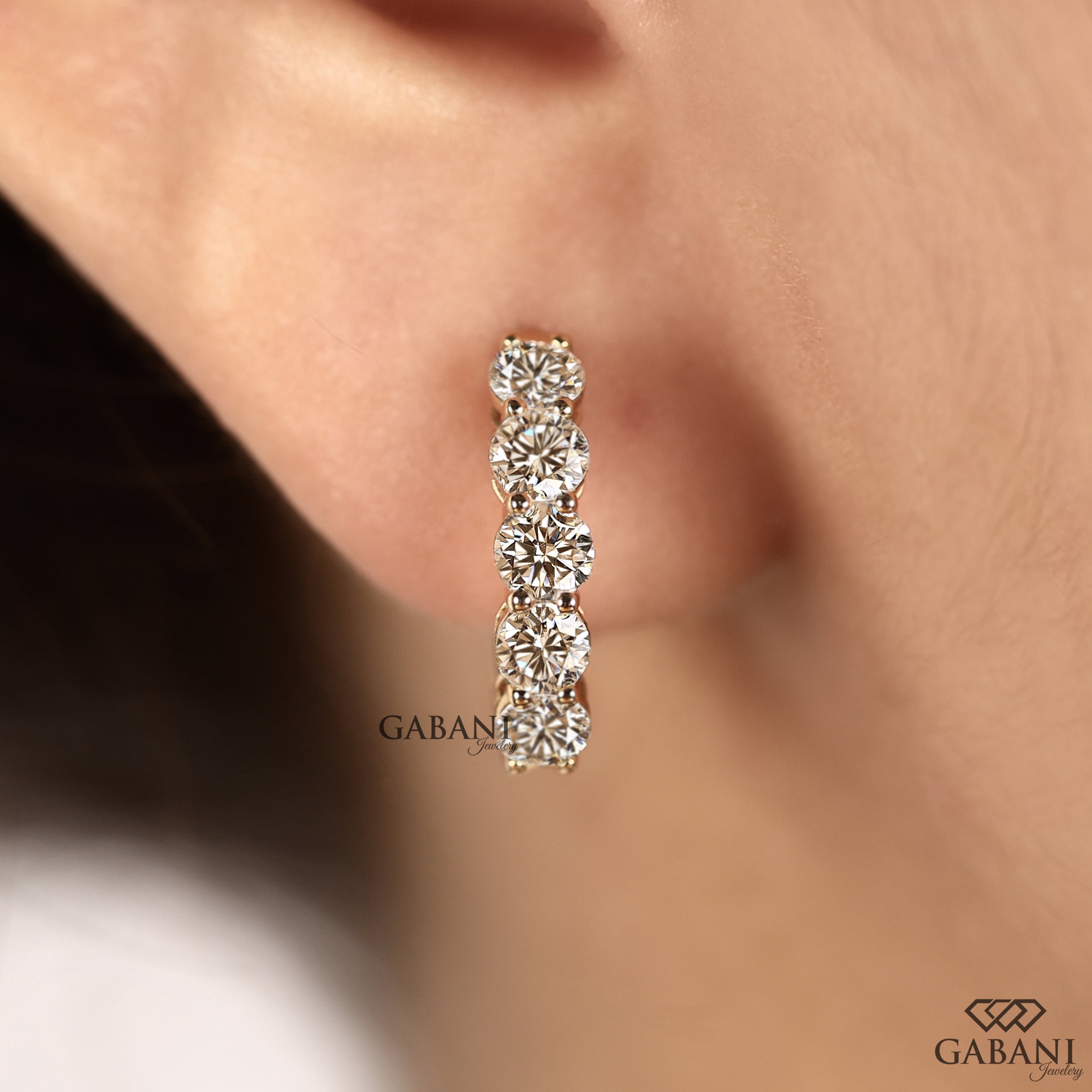 Round cut lab grown diamond hoop earrings in yellow gold with a classic huggie design