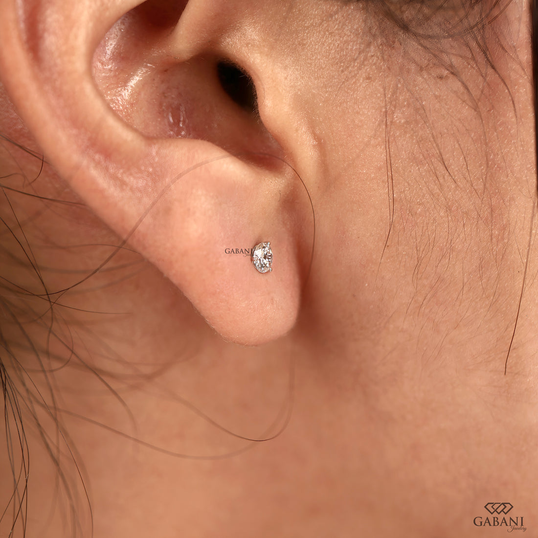 Round cut diamond stud earrings designed with a delicate prong setting