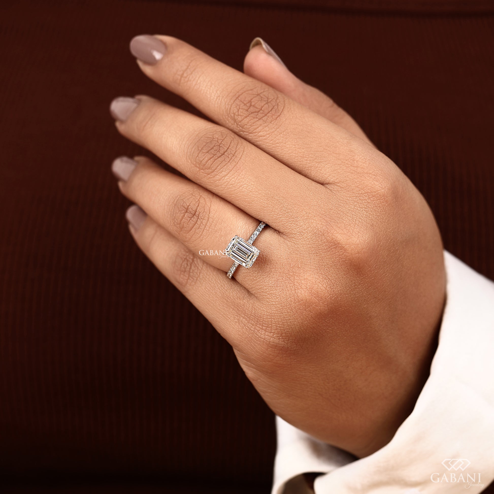 lab created diamond engagement ring with emerald cut center and hidden halo on a thin white gold band