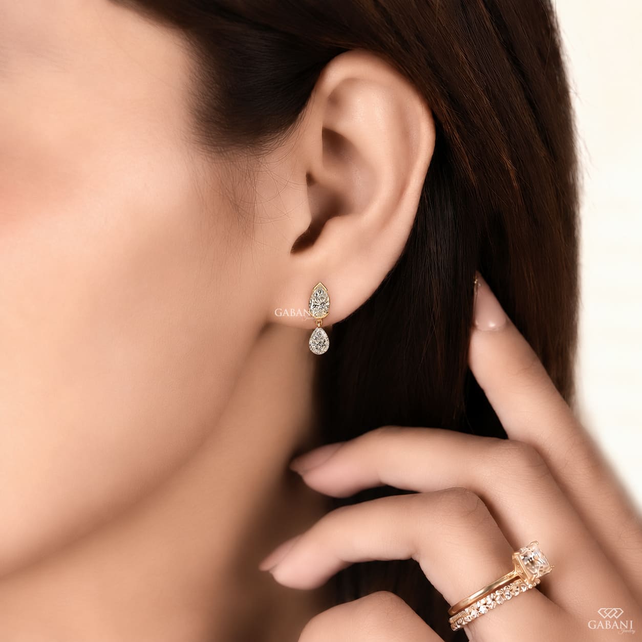 pear cut lab grown diamond drop earrings in yellow gold, featuring two sparkling pear-shaped diamonds on each earring in an elegant double teardrop design by Gabani Jewelry.