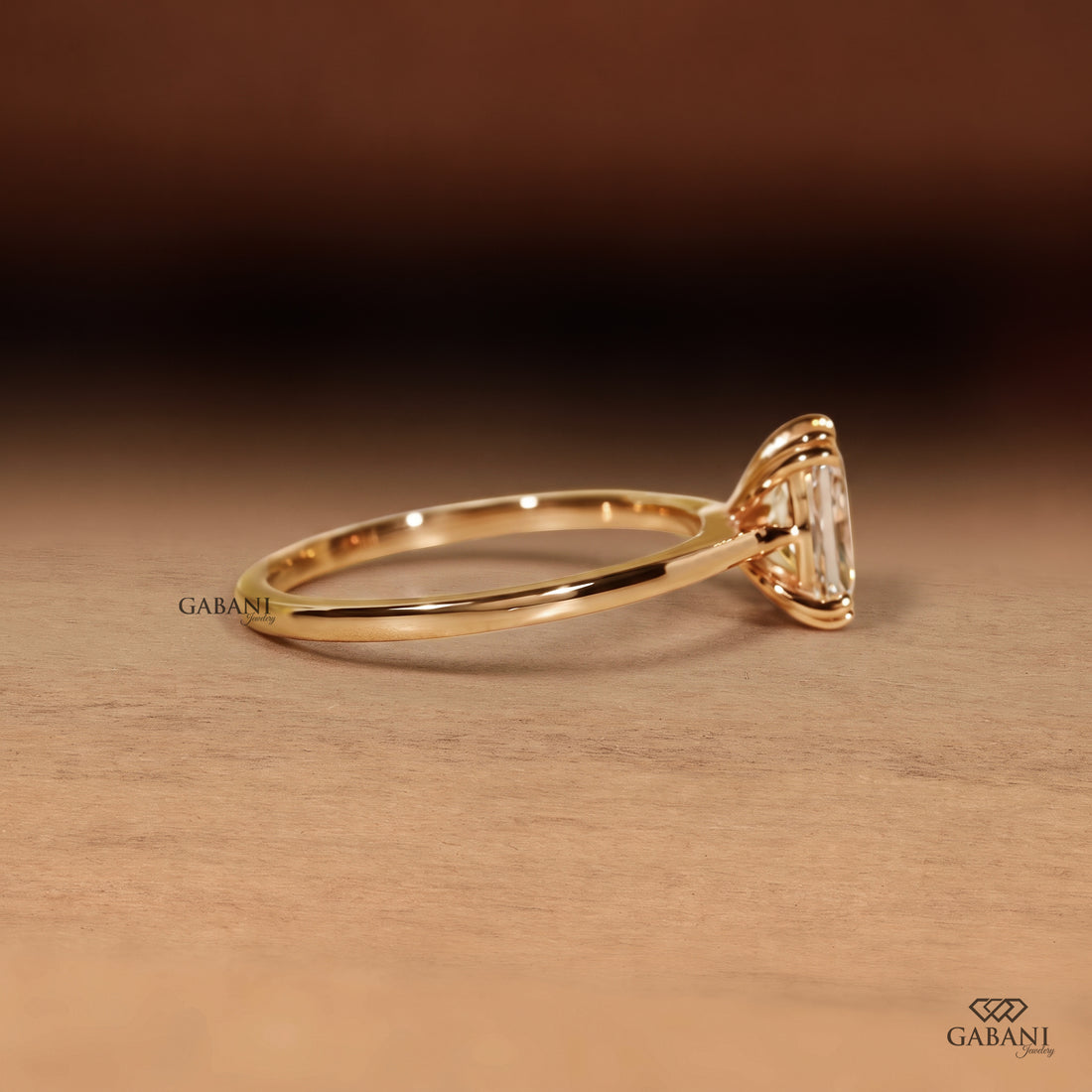 Radiant cut lab grown diamond engagement ring in 18K yellow gold with double claw prongs, elongated center stone and a slim polished solitaire band.