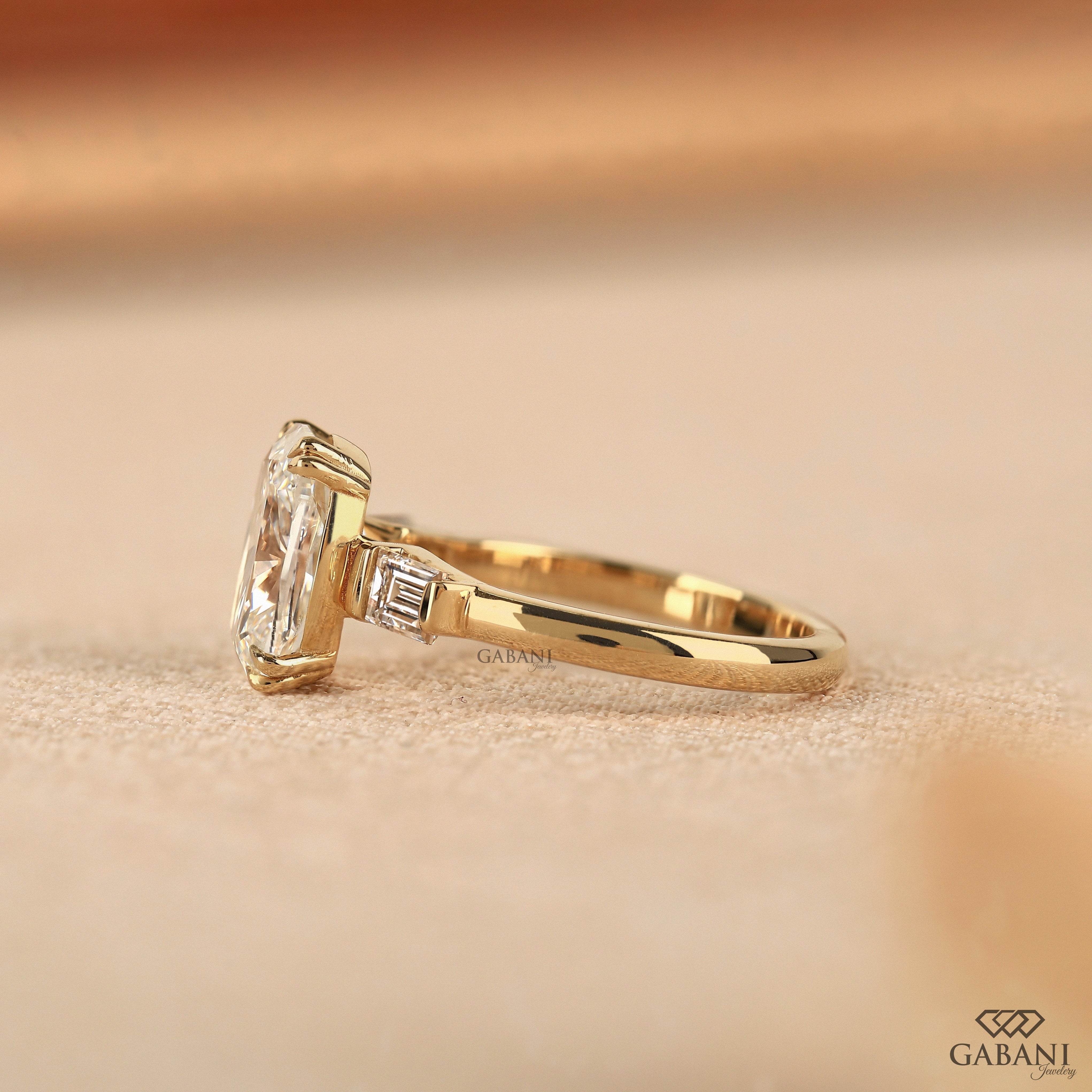 Side view of three stone cushion cut lab grown diamond anniversary ring
