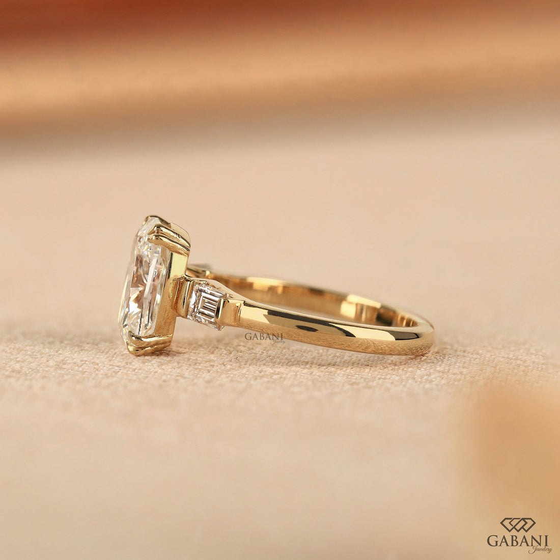 Side view of three stone cushion cut lab grown diamond anniversary ring
