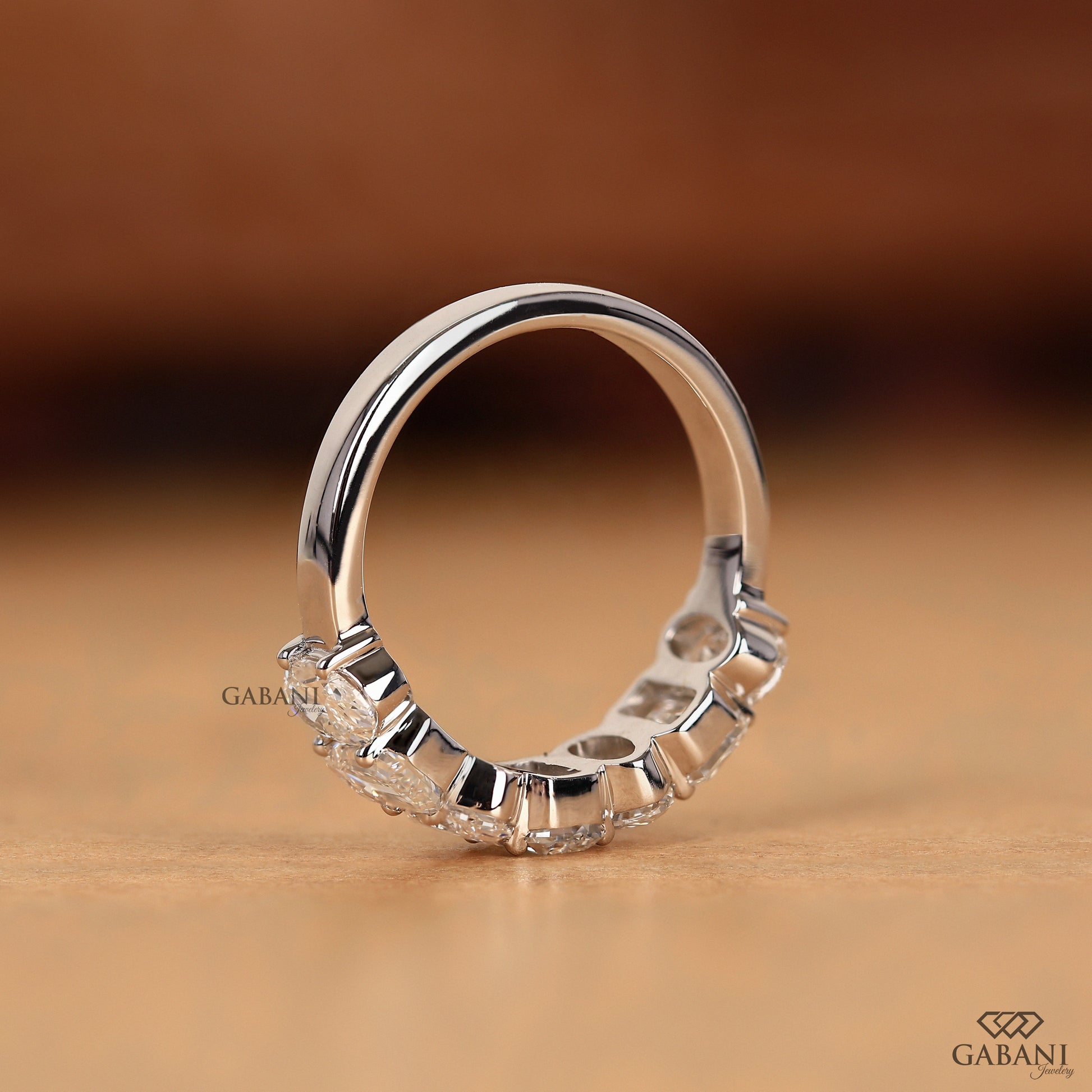 solid white gold band with emerald and oval cut cvd lab diamonds