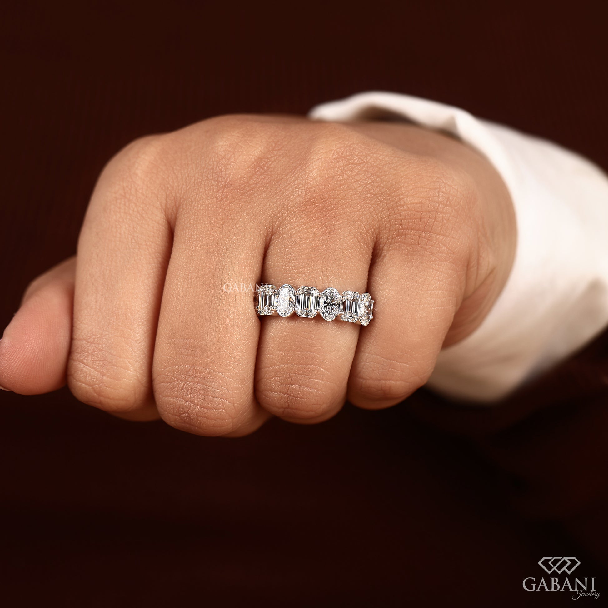emerald and oval cut diamond wedding ring in smooth white gold setting